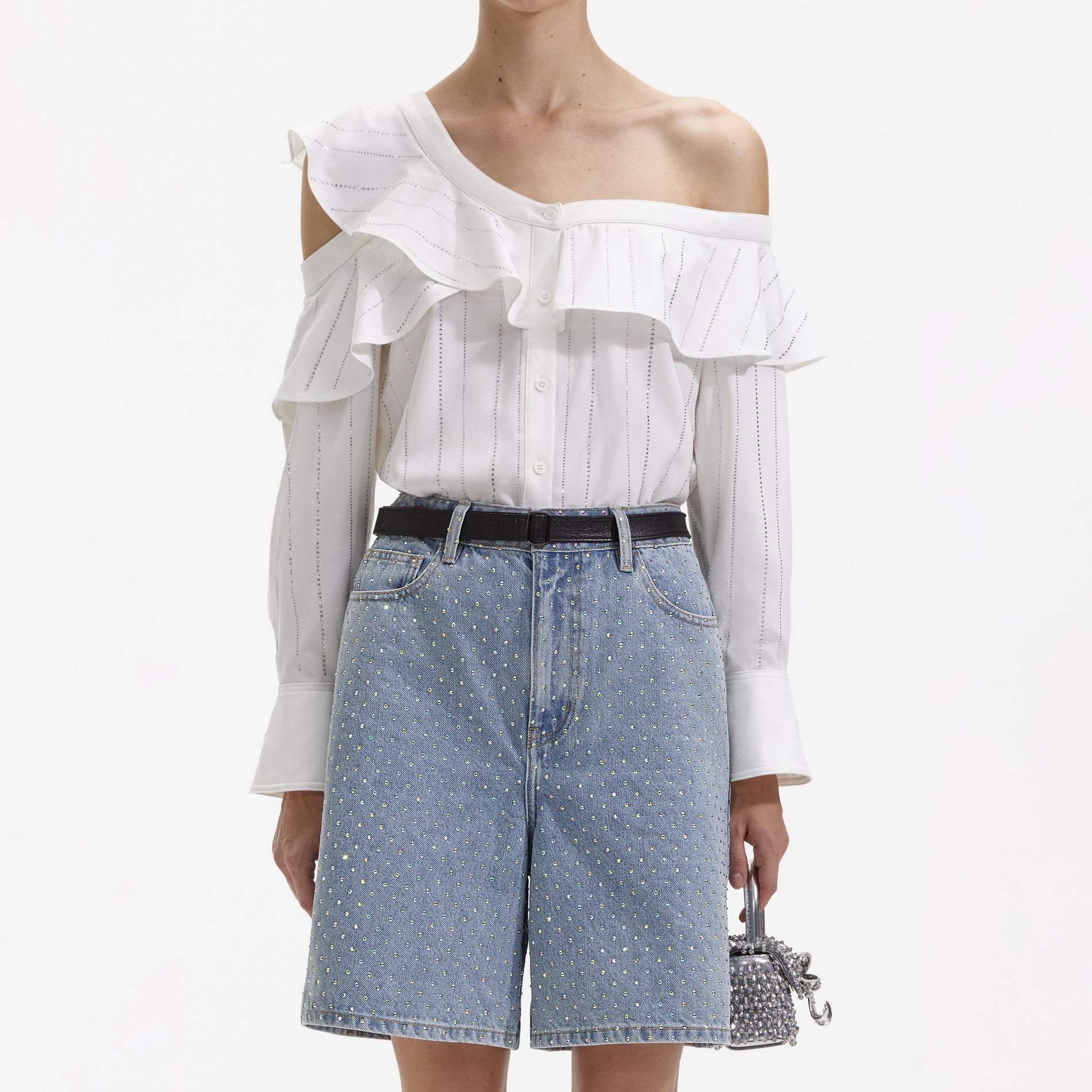 A close up of a woman wearing the Rhinestone Denim Shorts