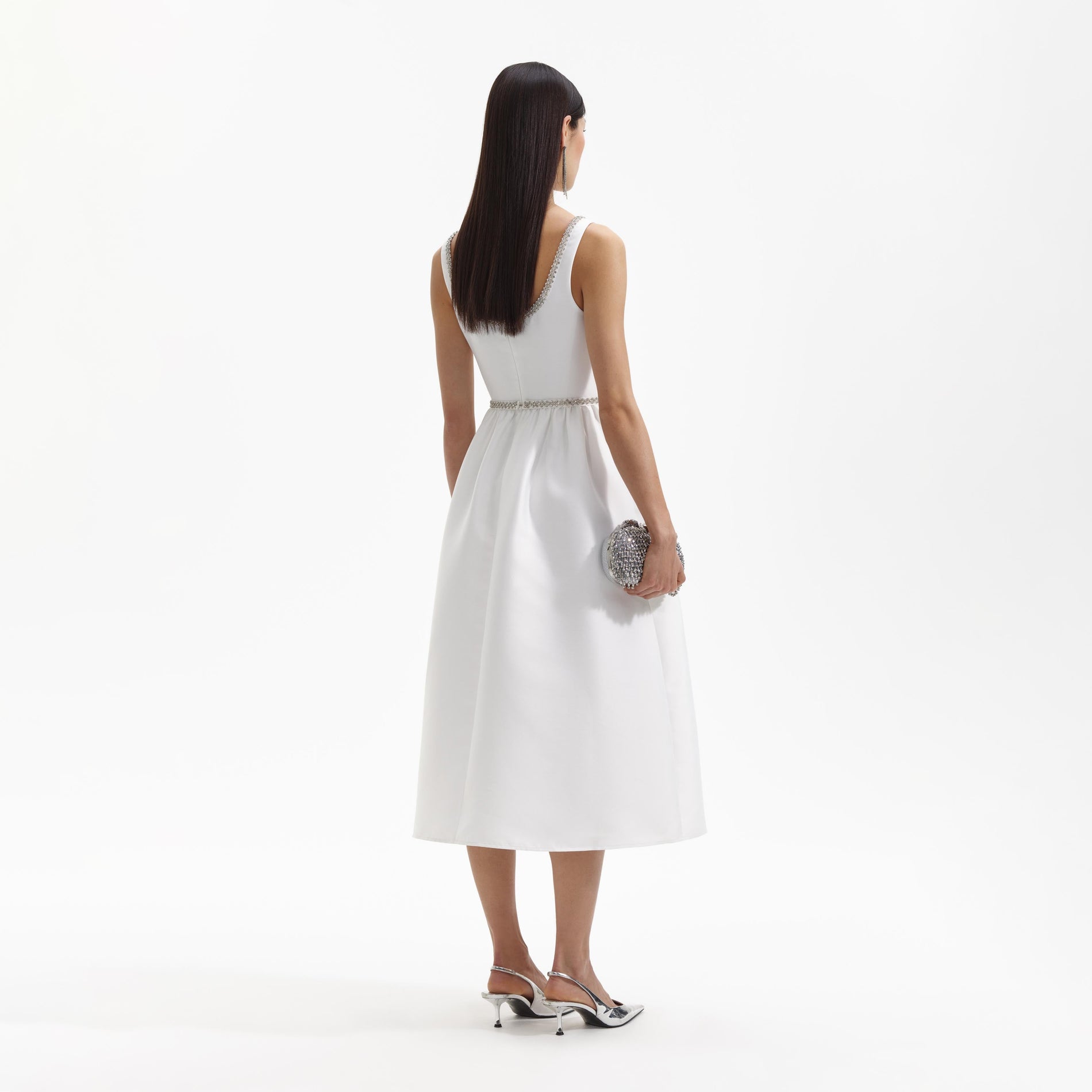 Back view of a woman wearing the White Taffeta Diamante Bow Midi Dress