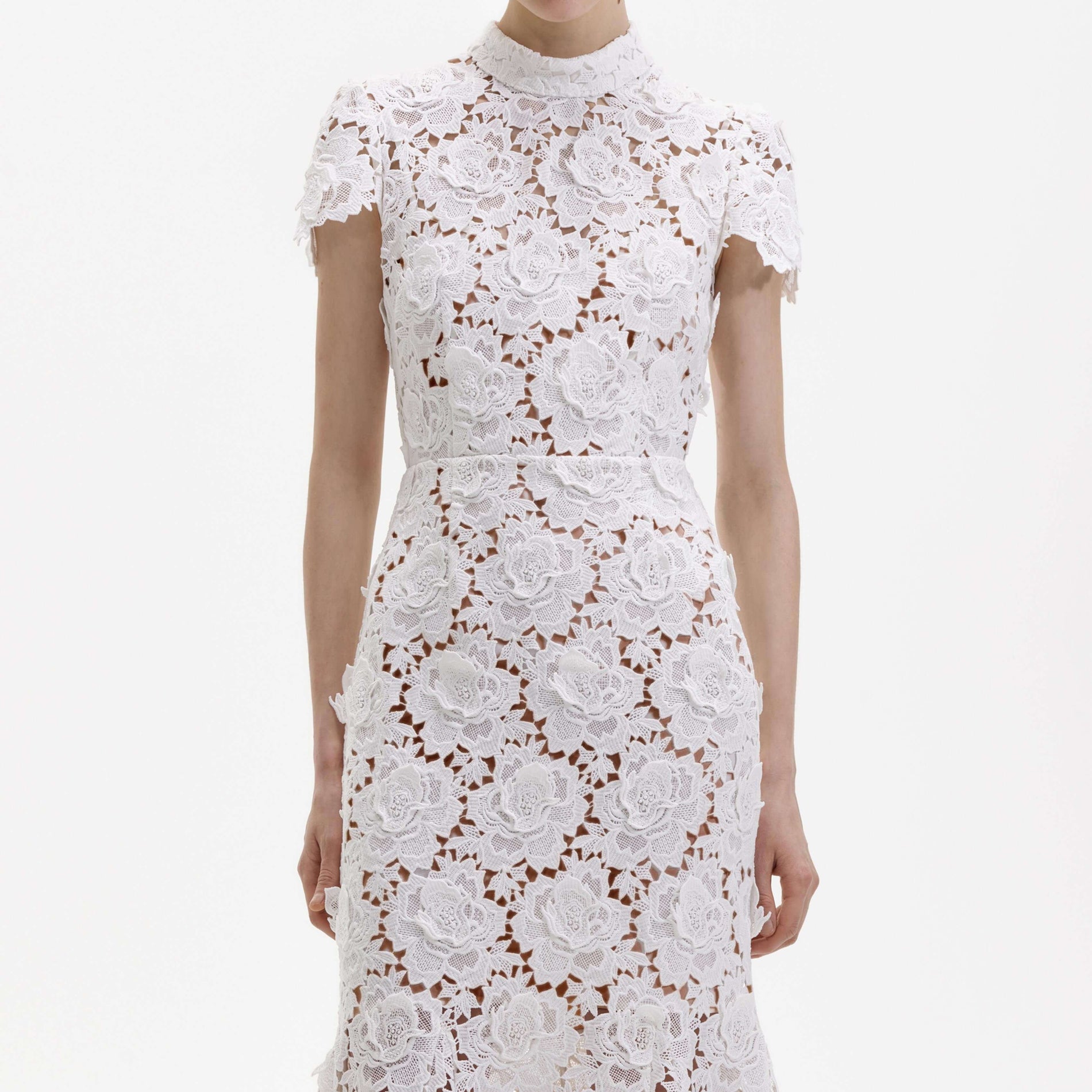 A close up of a woman wearing the White 3D Flower Lace Midi Dress
