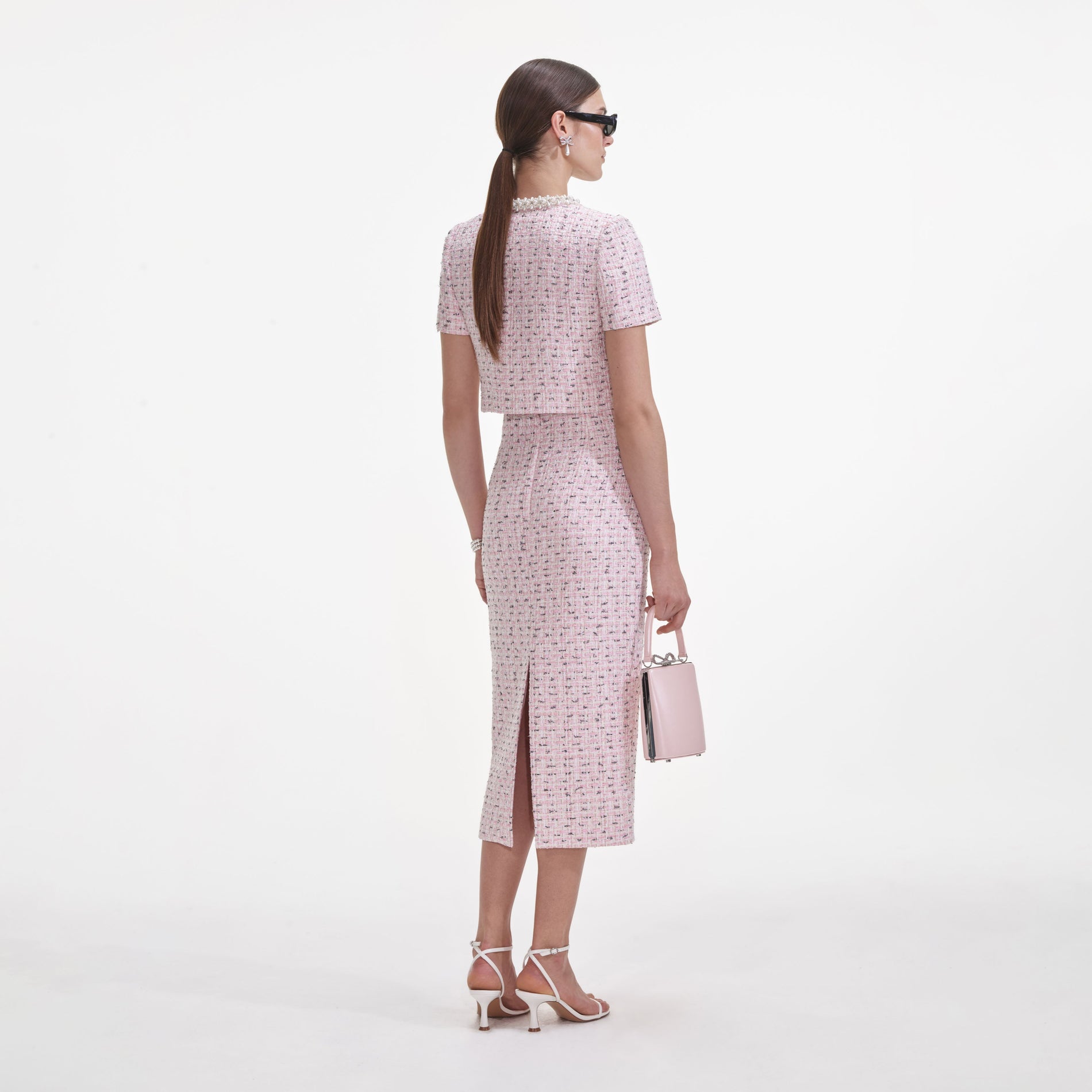 Back view of a woman wearing the Pink Boucle Pearl Top