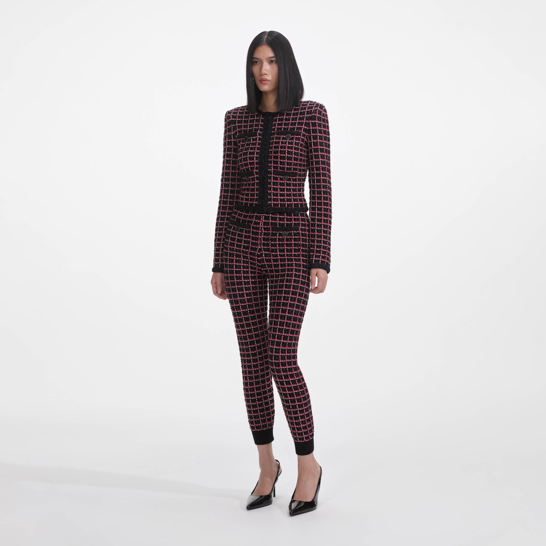 Side view of a woman wearing the Black And Red Check Knit Leggings