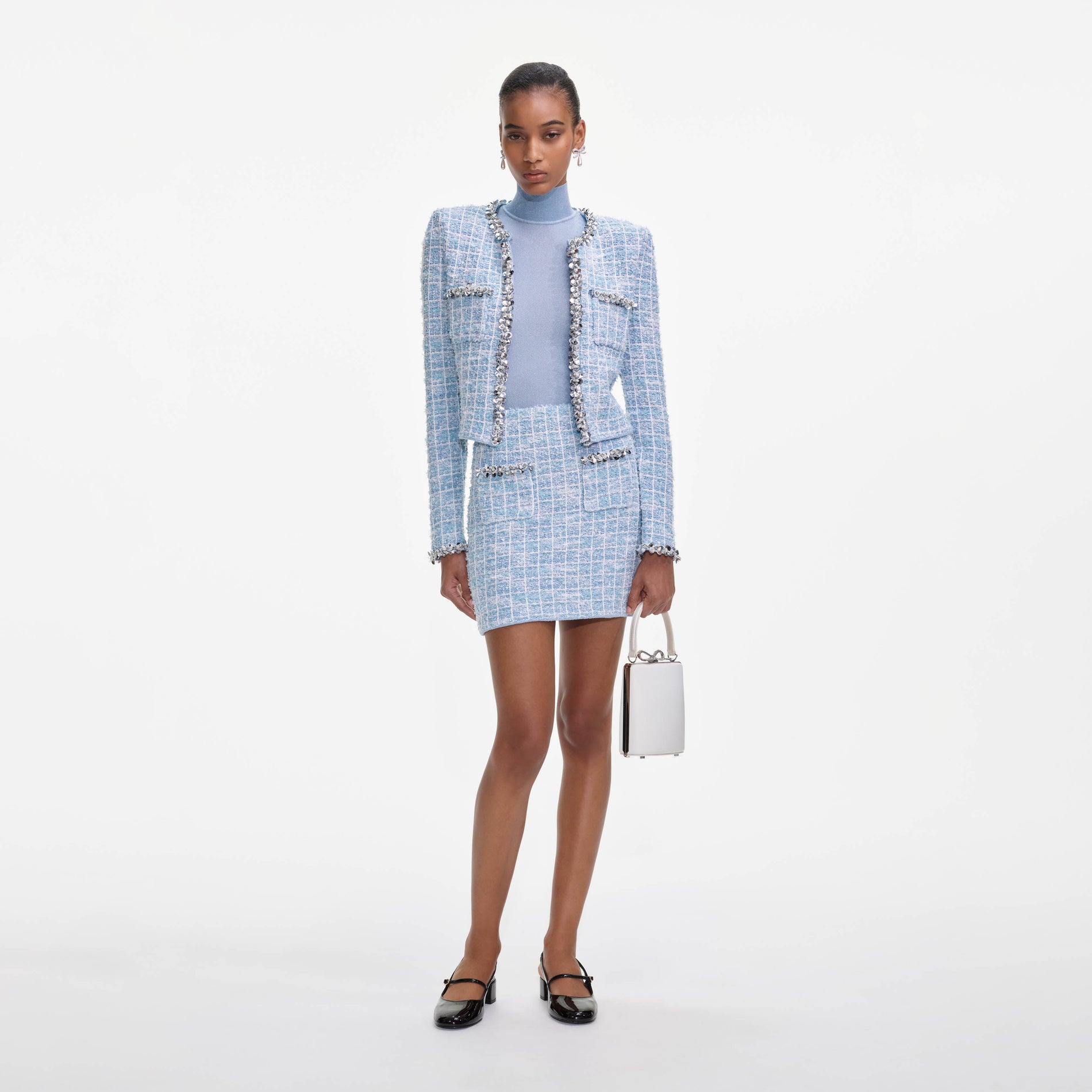 A close up of a woman wearing the Blue Check Knit Mini Skirt