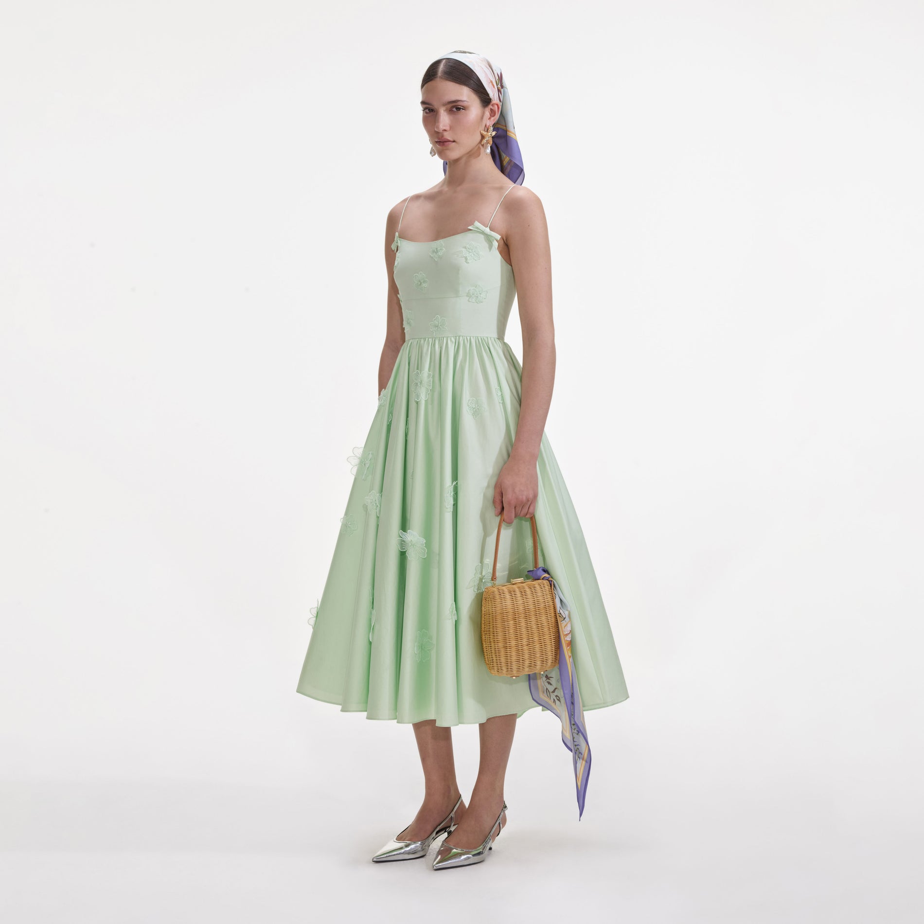 Side view of a woman wearing the Green Cotton Flower Midi Dress