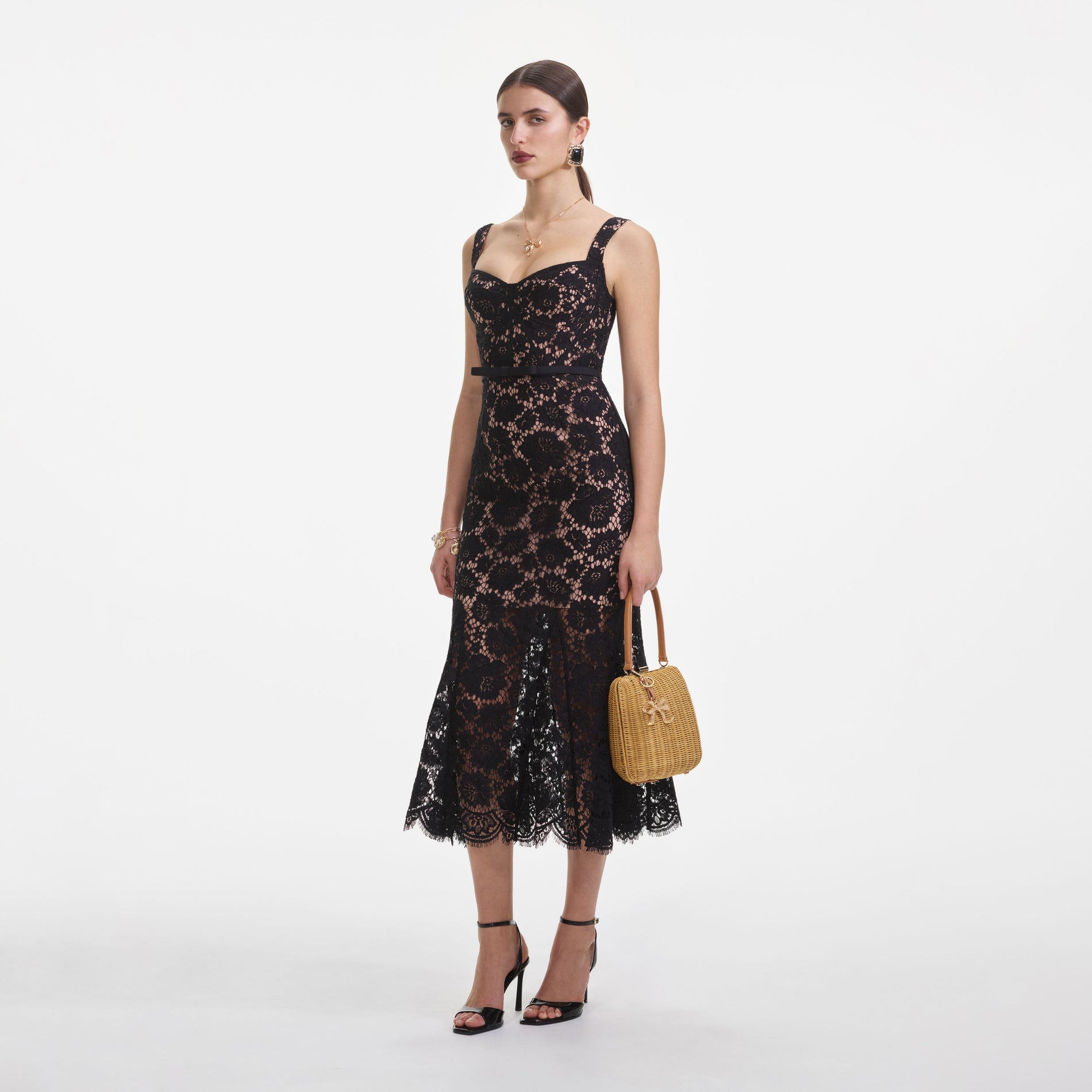 Side view of a woman wearing the Black Fine Lace Midi Dress