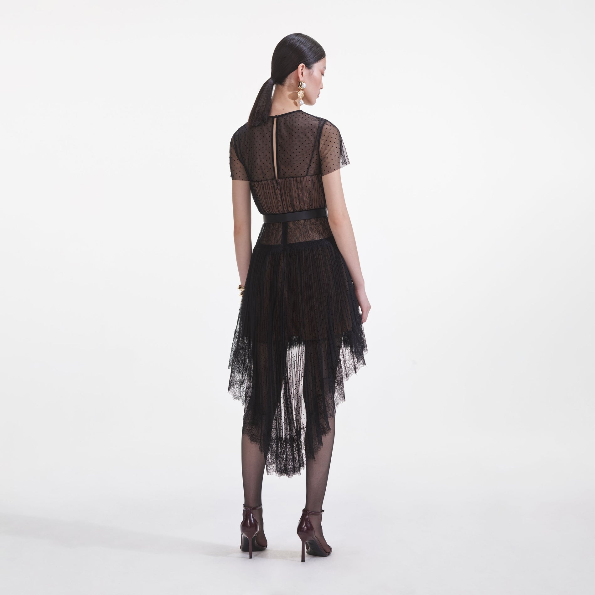 Back view of a woman wearing the Black Dot Mesh Mini Dress