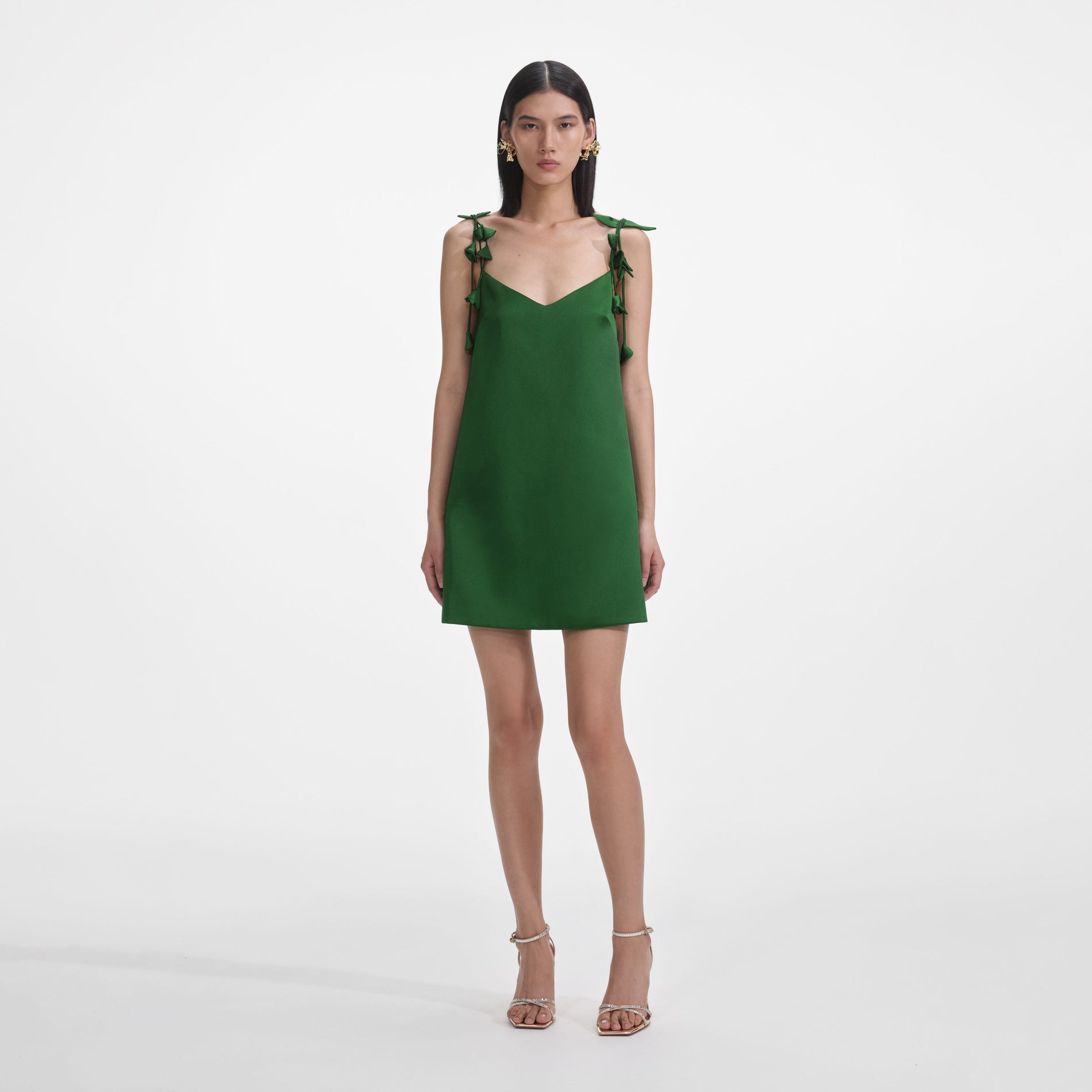 Front view of a woman wearing the Green Satin Flower Mini Dress