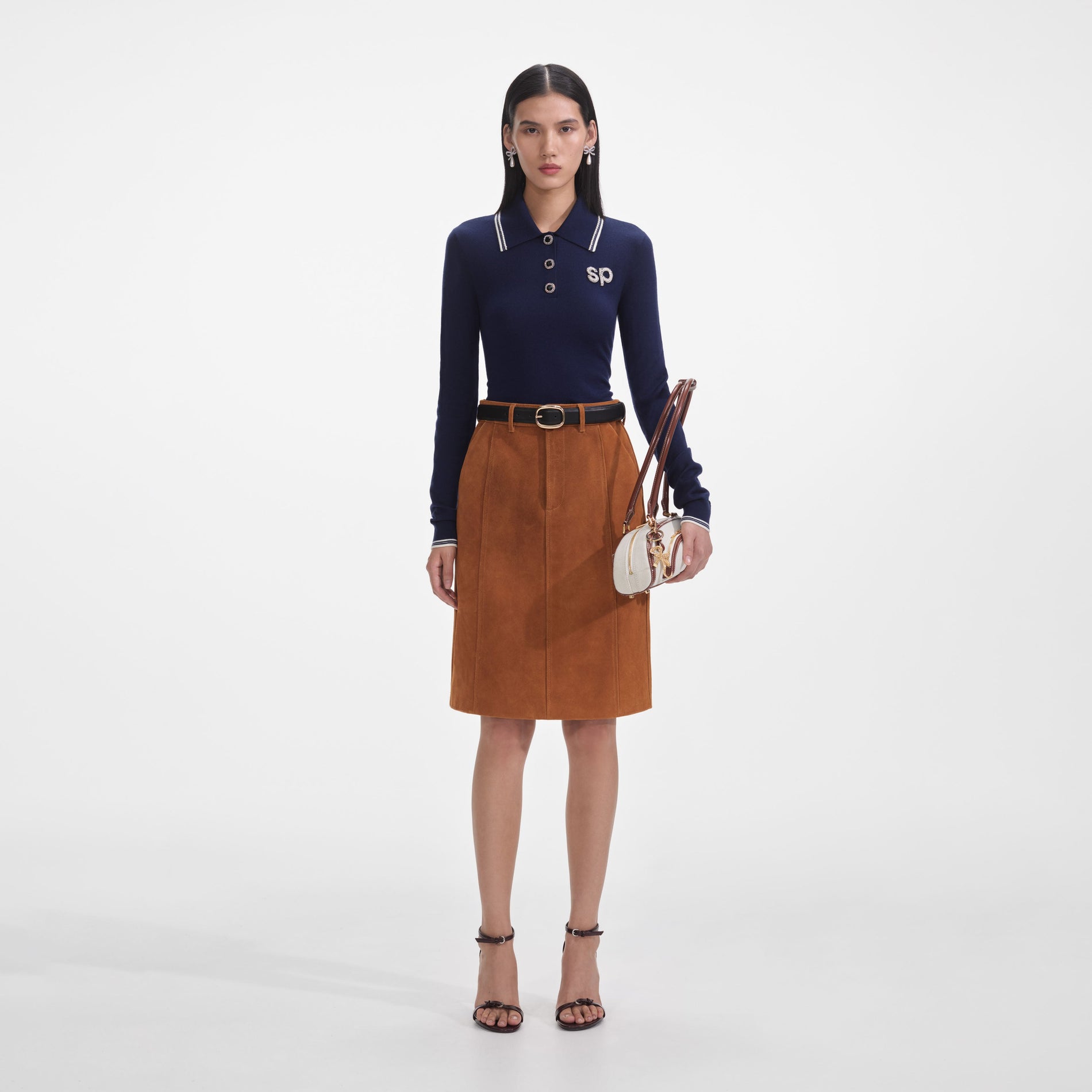 Front view of a woman wearing the Navy Knit Long Sleeve SP Polo Top