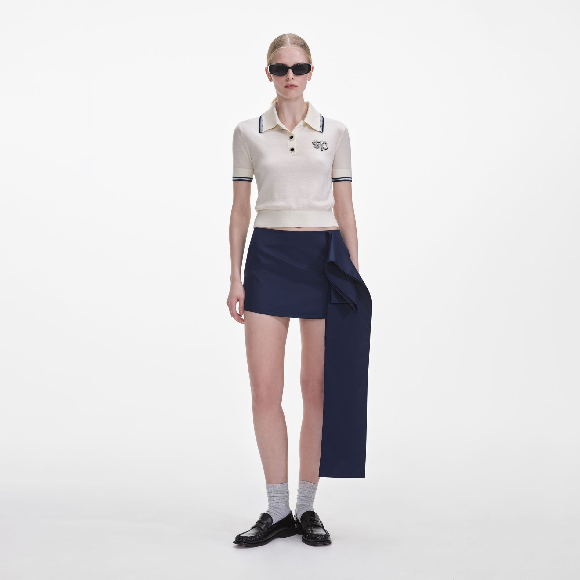 Front view of a woman wearing the Cream Knit SP Polo Top