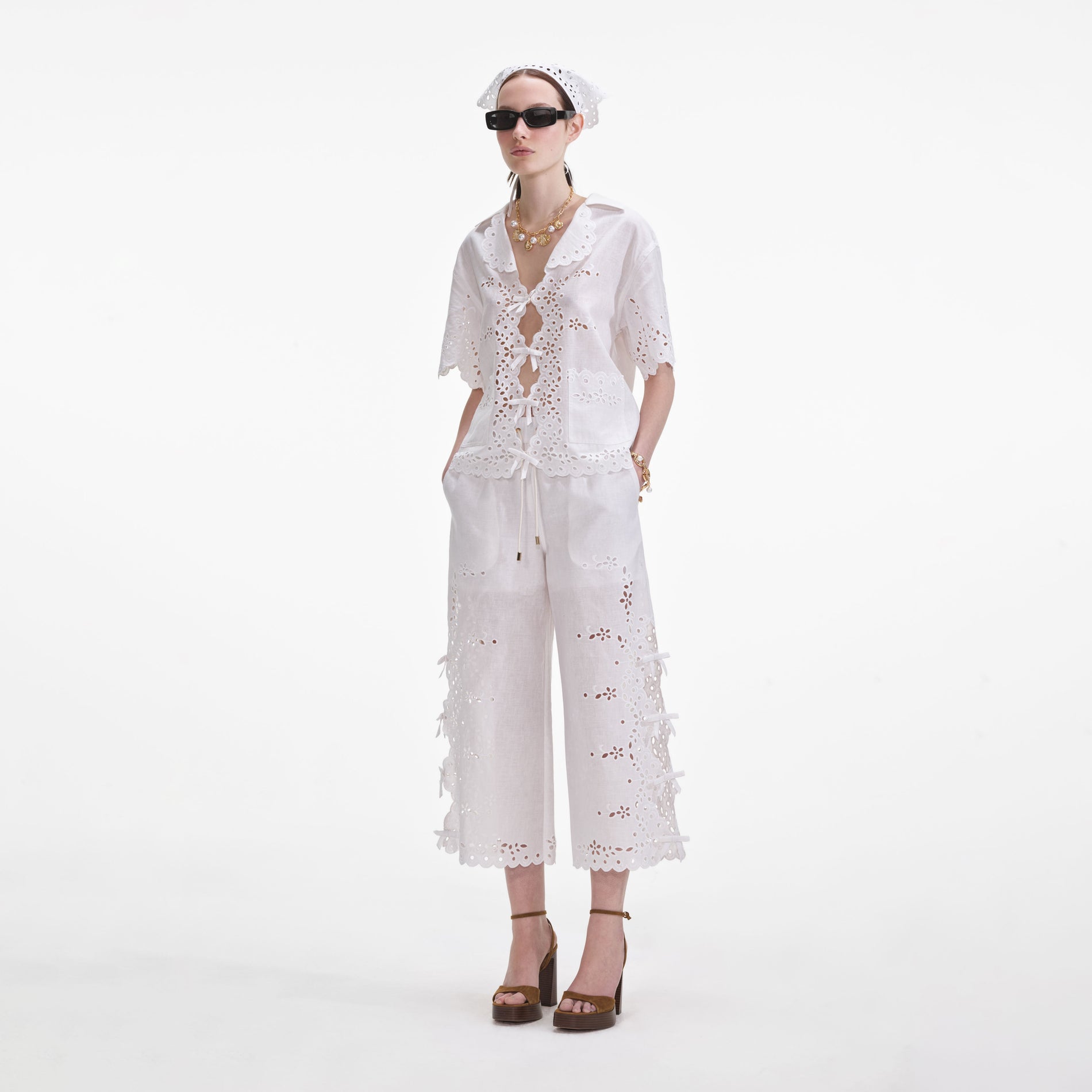 Side view of a woman wearing the Cream Linen Embroidered Shirt