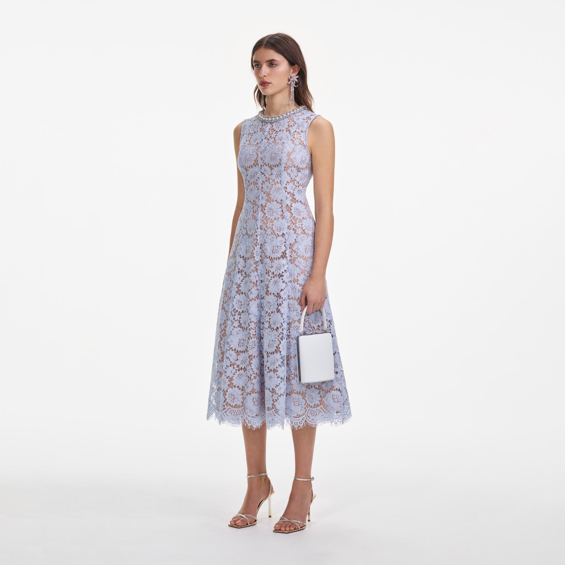 Side view of a woman wearing the Blue Fine Lace Pearl Midi Dress