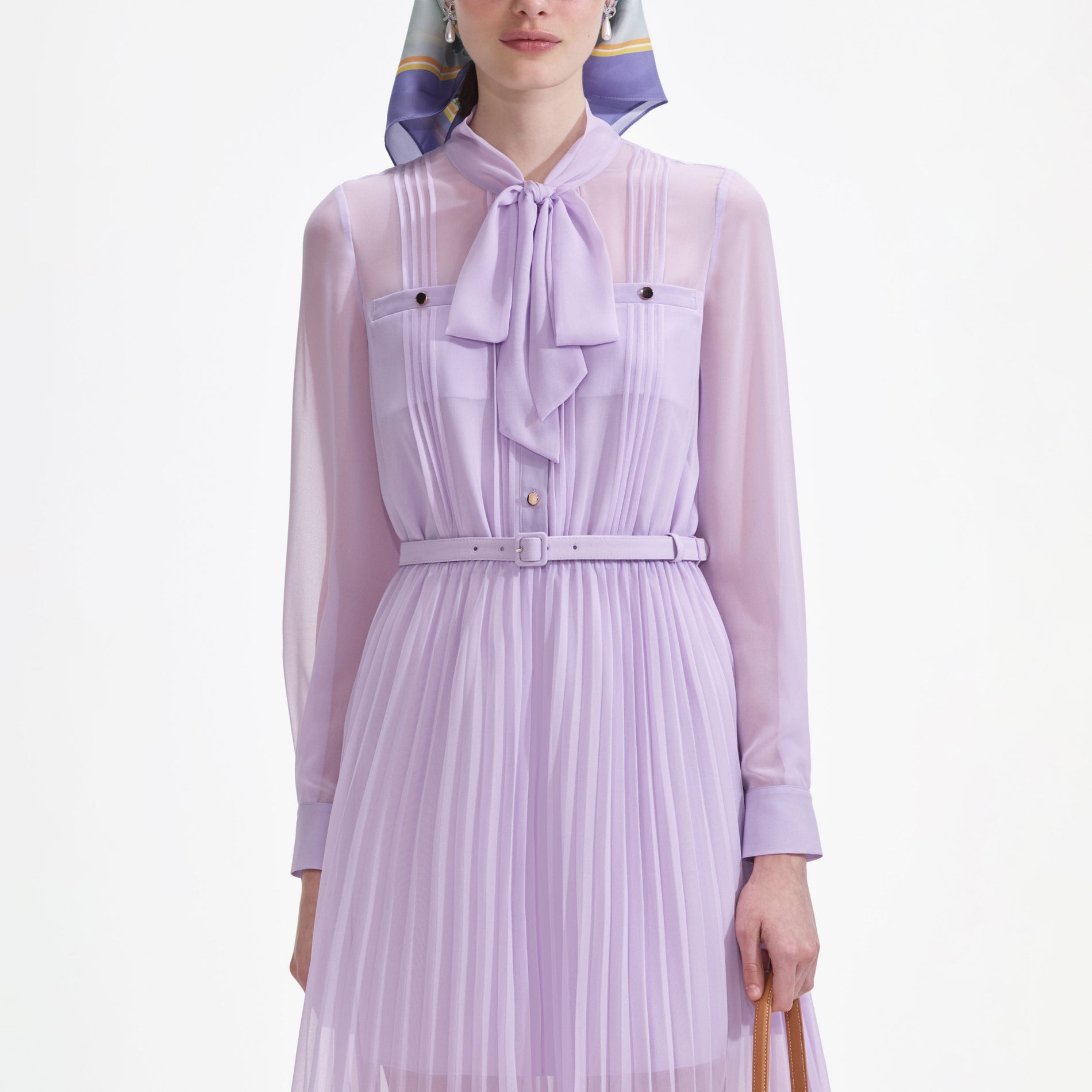 A close up of a woman wearing the Lilac Chiffon Pussy Bow Midi Dress