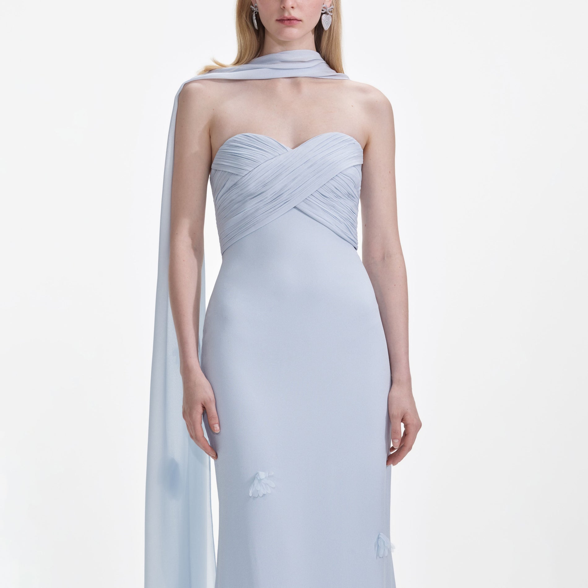 A close up of a woman wearing the Blue Georgette Flower Maxi Dress