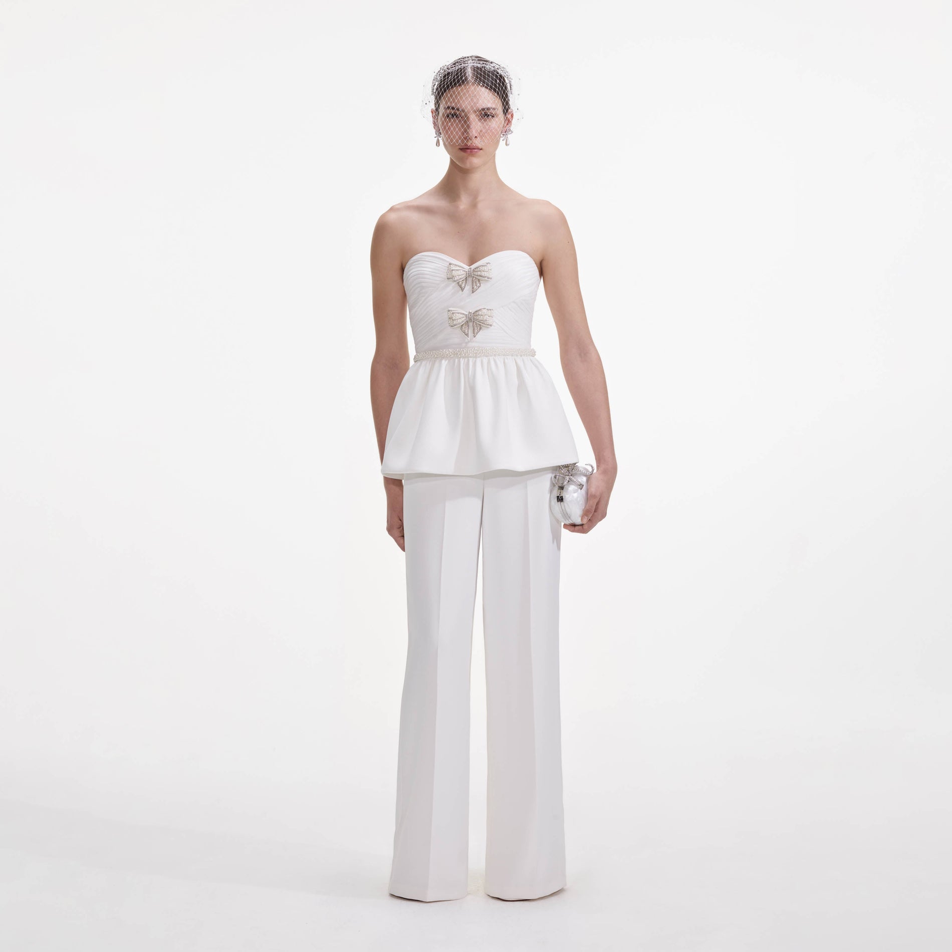 Front view of a woman wearing the White Organza Bow Jumpsuit