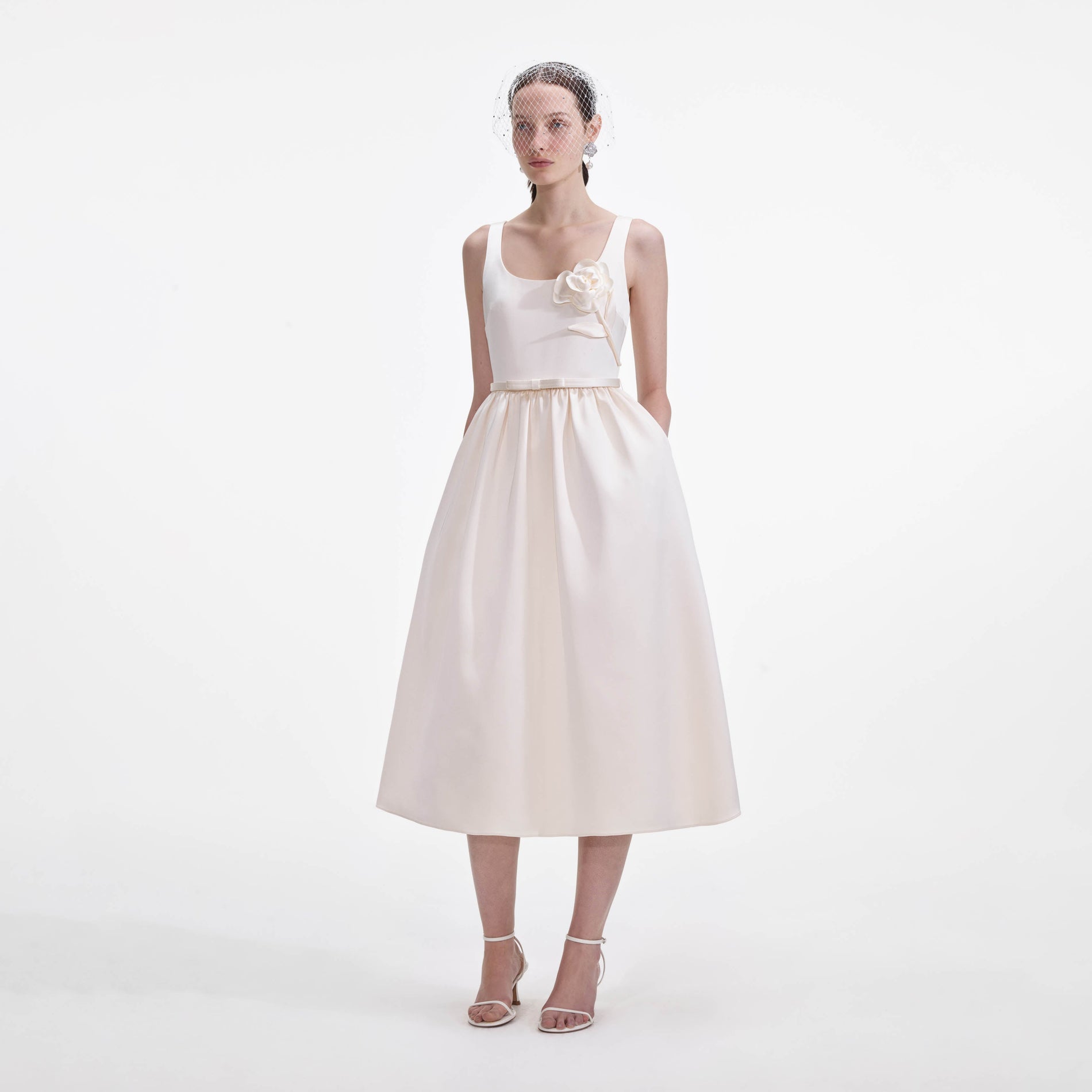 Side view of a woman wearing the Cream Satin Flower Midi Dress