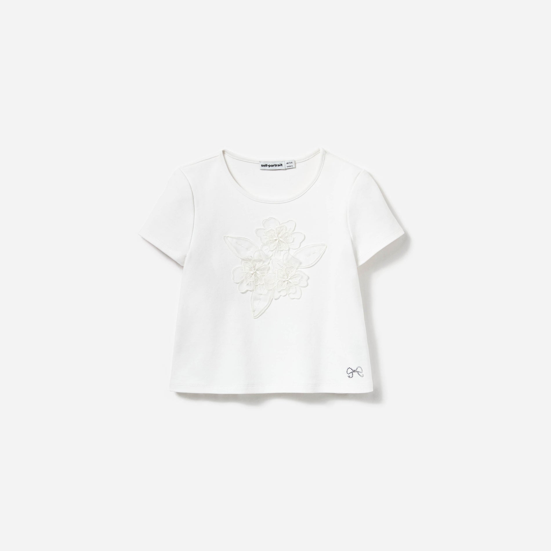 Front view of a woman wearing the Cream Jersey Flower Top