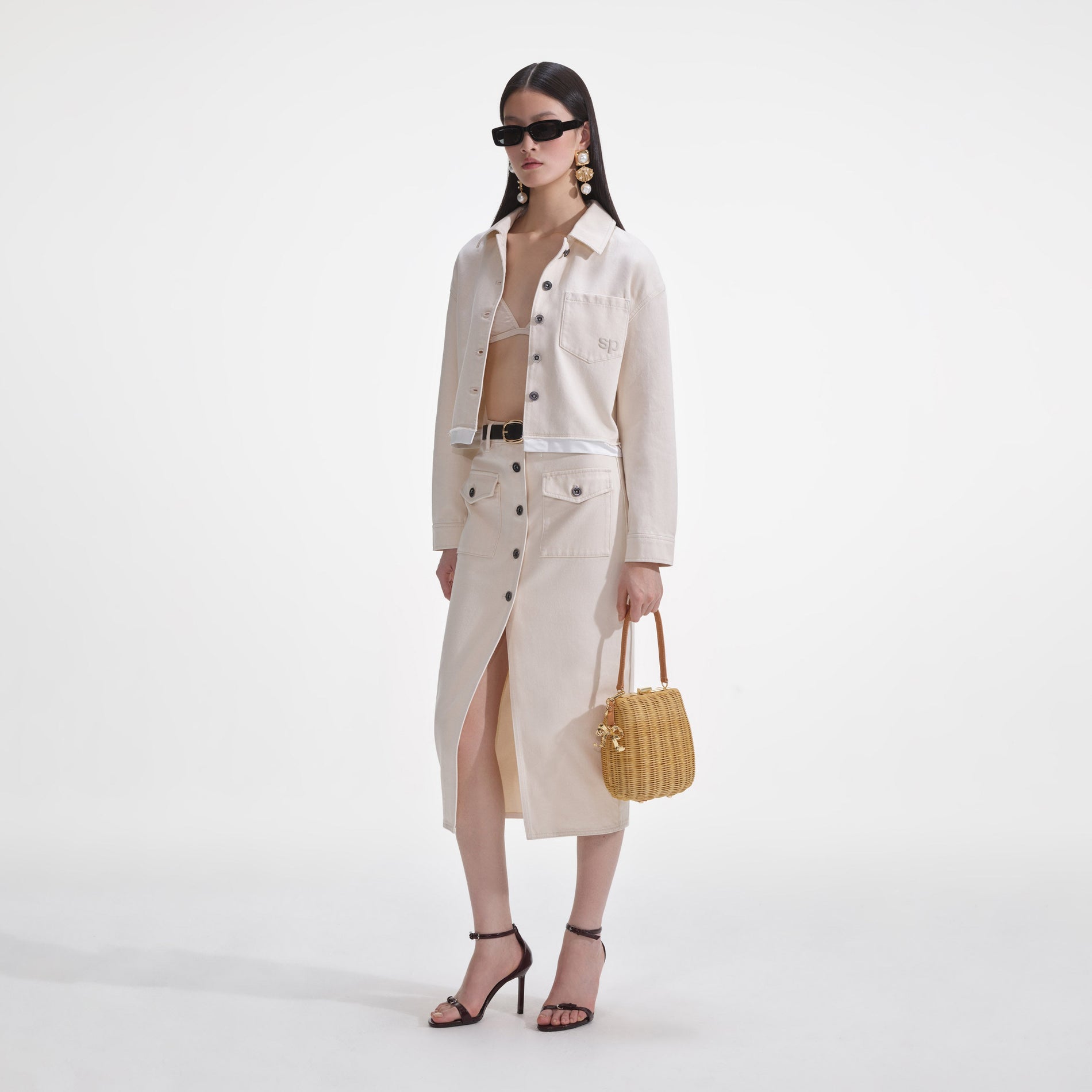 Side view of a woman wearing the Cream Denim Jacket