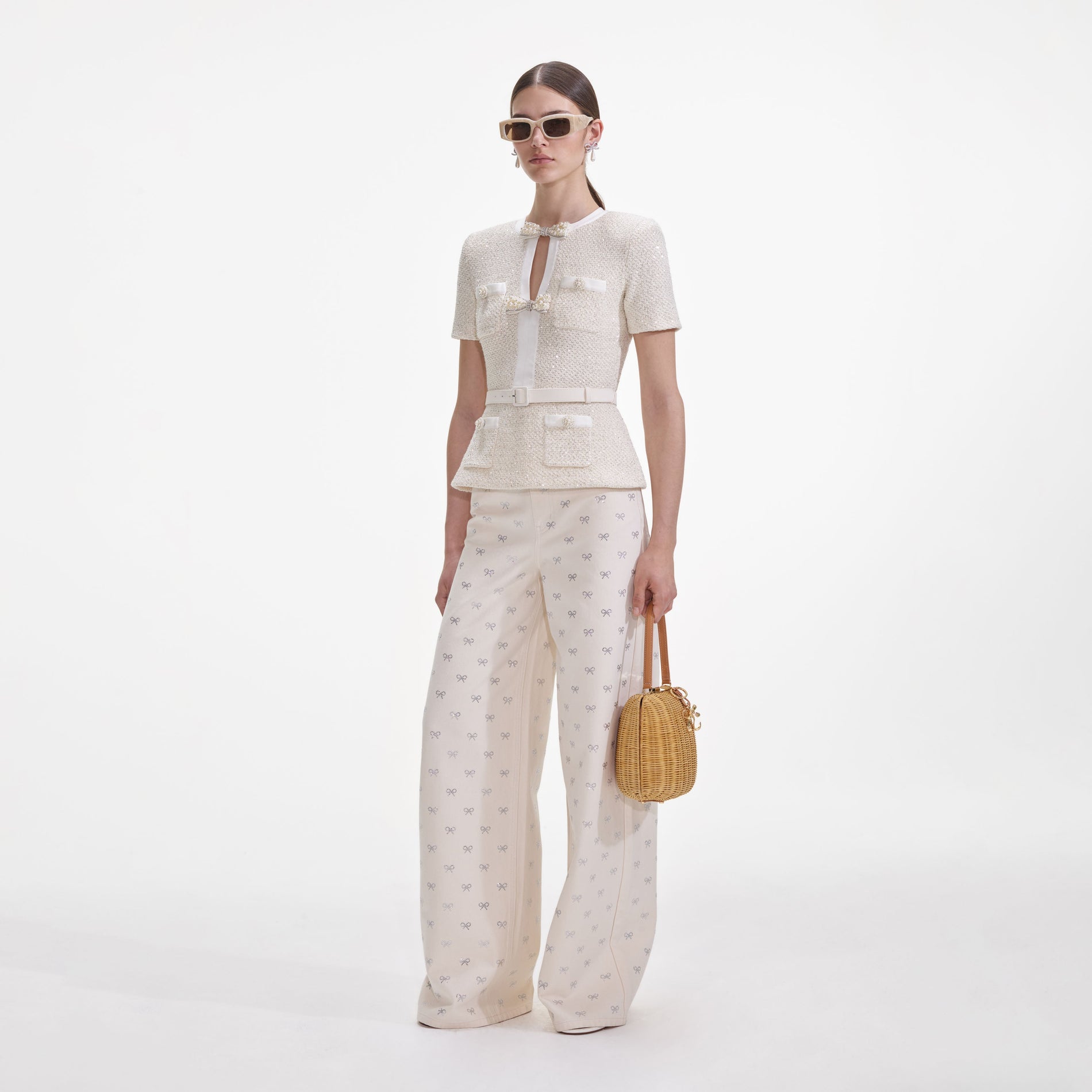 Side view of a woman wearing the Cream Sequin Knit Top