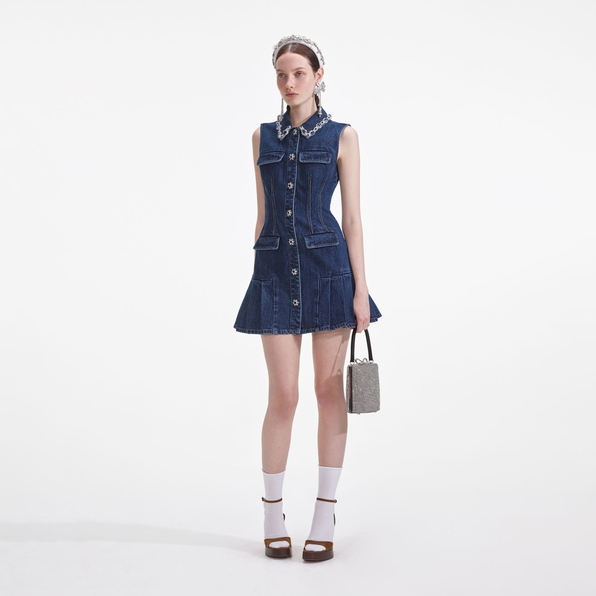 Side view of a woman wearing the Denim Sleeveless Mini Dress