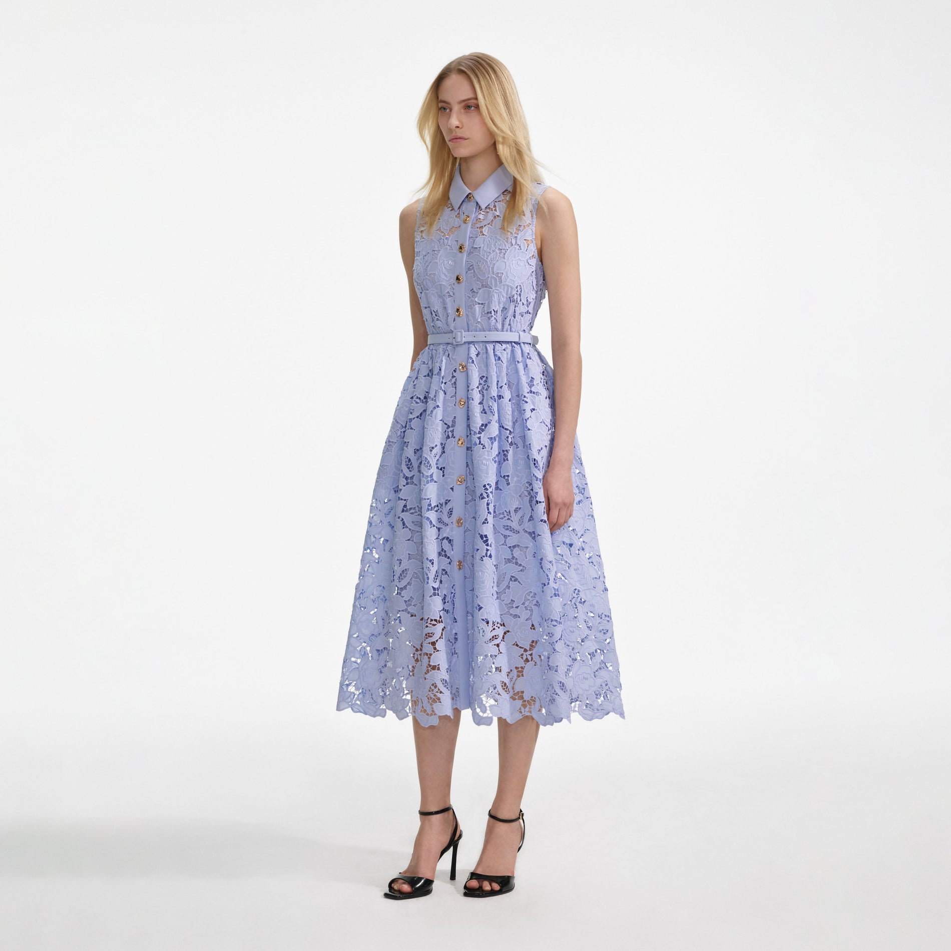 Side view of a woman wearing the Blue Lace Sleeveless Midi Dress