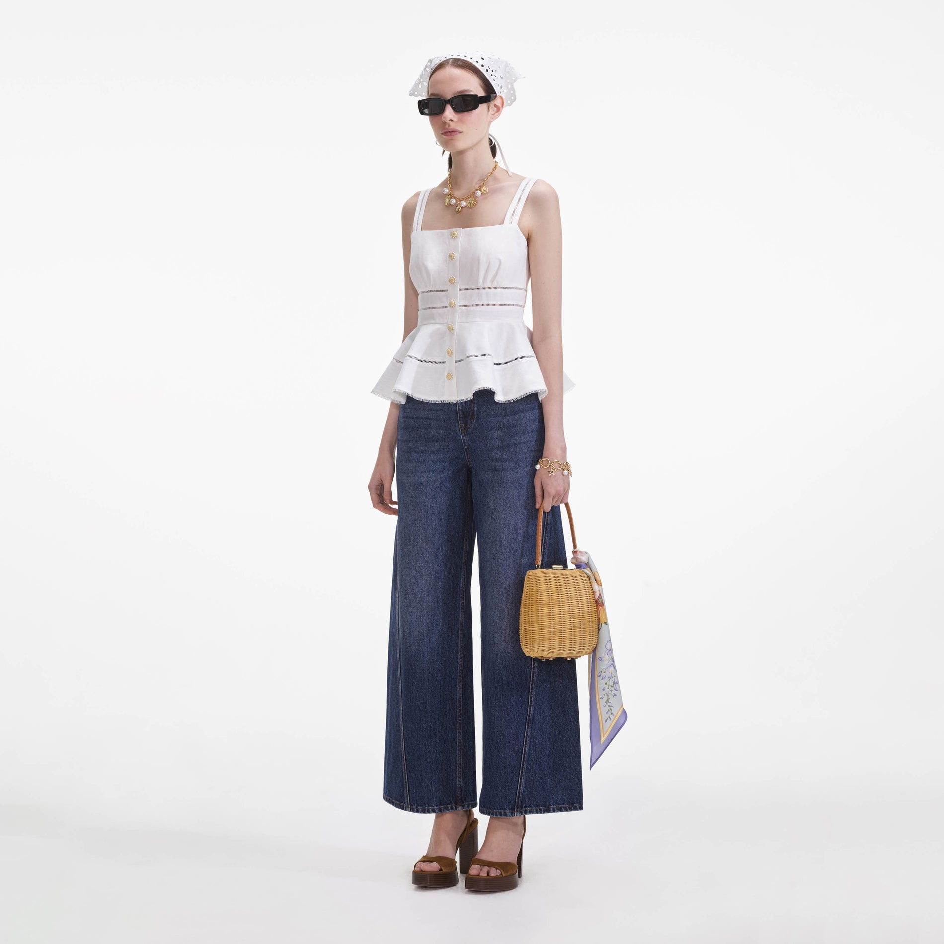 Side view of a woman wearing the White Linen Peplum Top