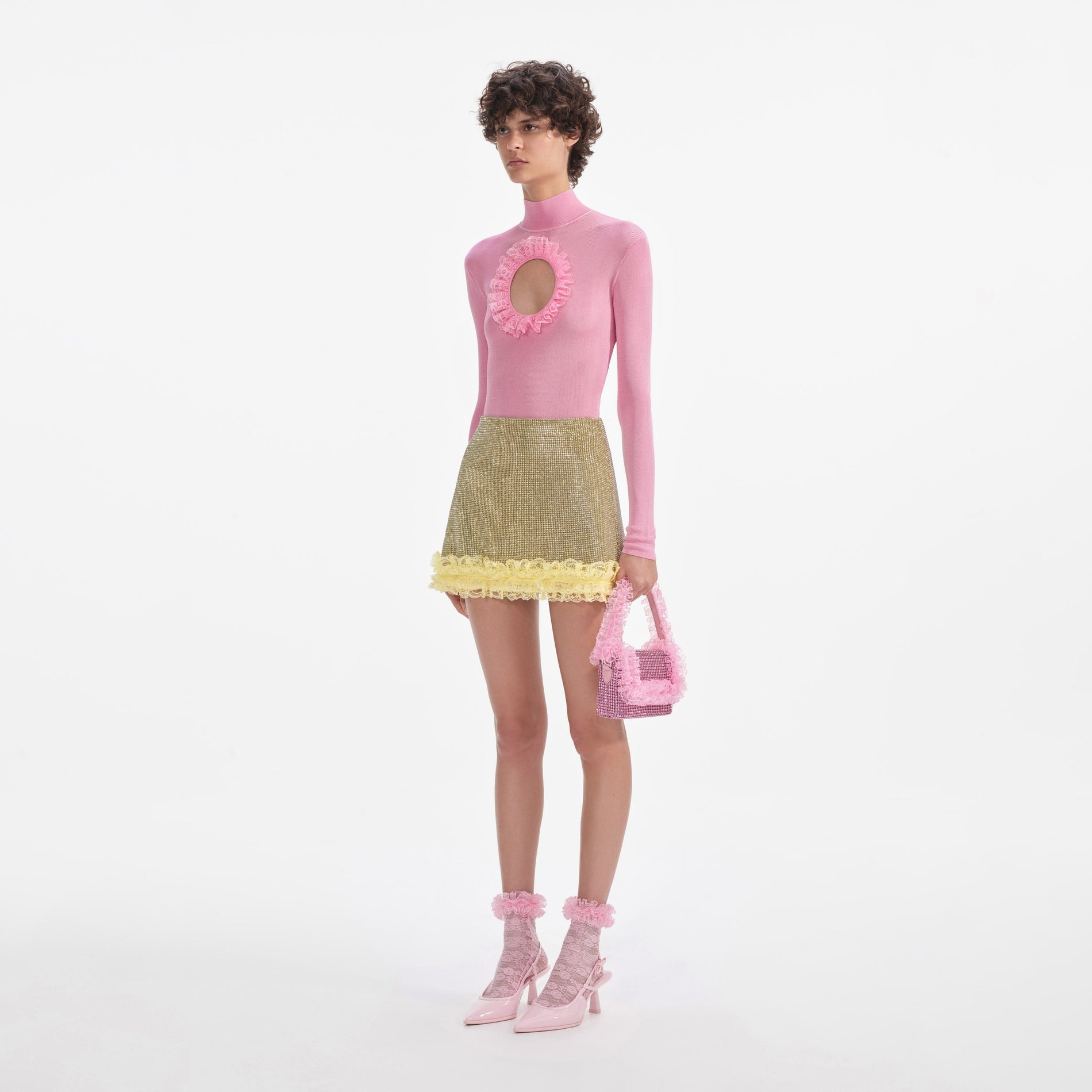 Side view of a woman wearing the Yellow Crystal Chainmail Mini Skirt
