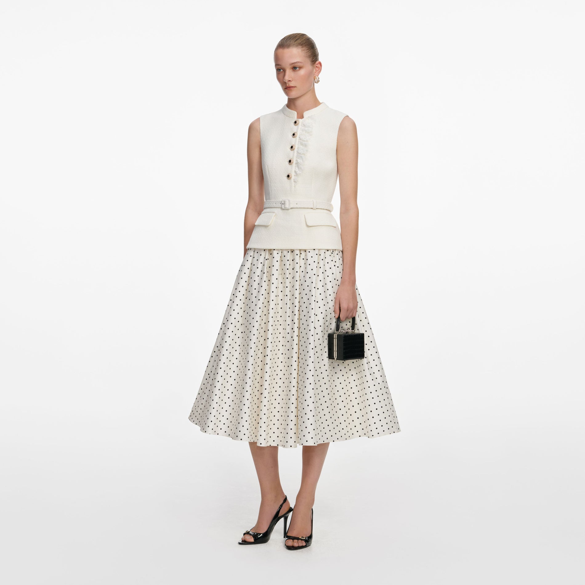 Side view of a woman wearing the Cream Boucle Polka Dot Midi Dress