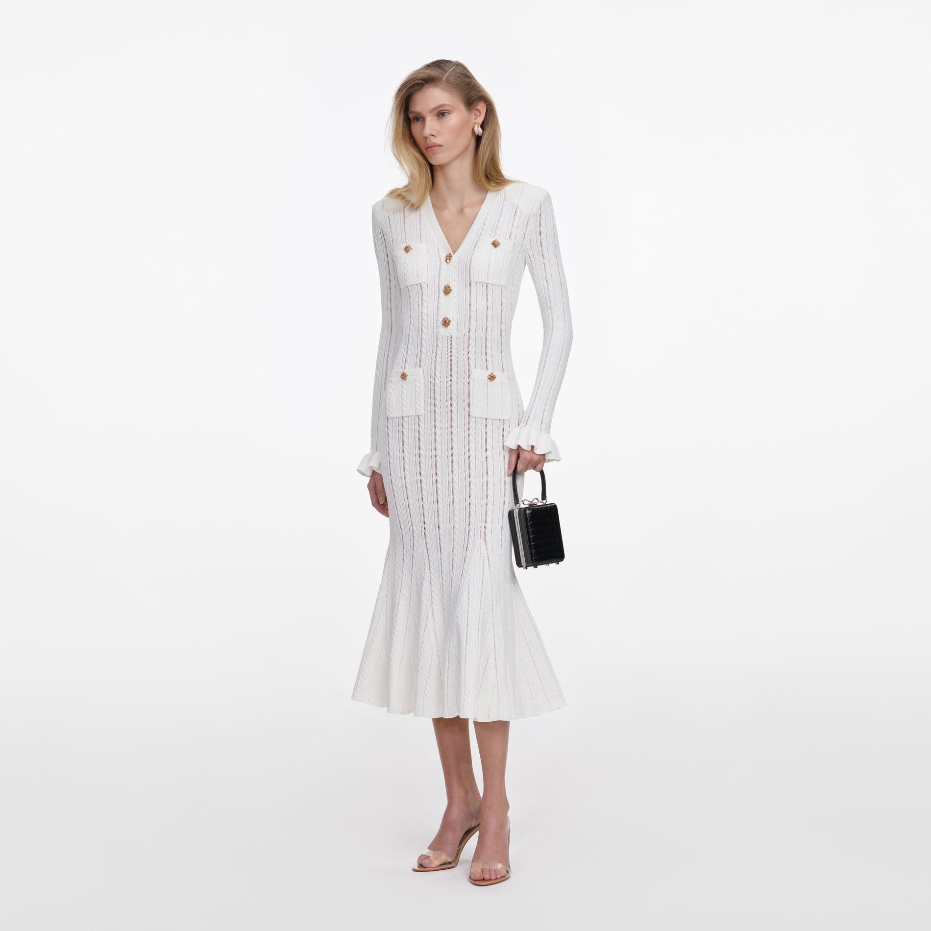 Side view of a woman wearing the White Pointelle Knit Midi Dress