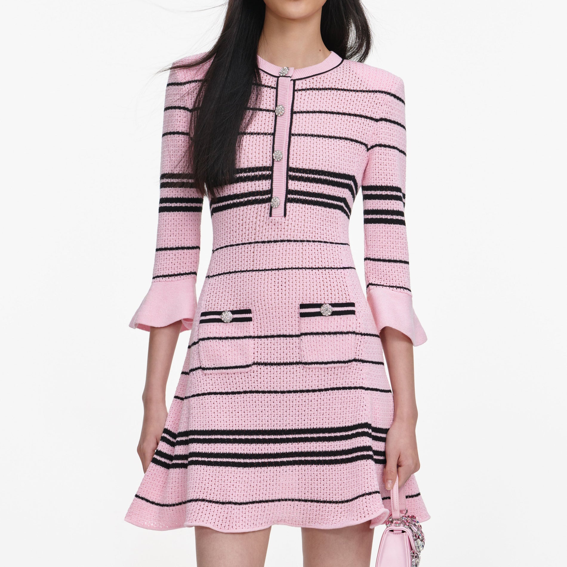 A close up of a woman wearing the Pink Stripe Knit Mini Dress