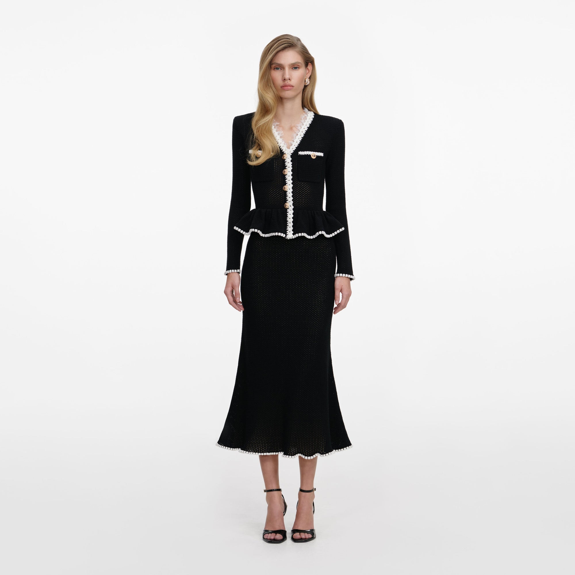 Front view of a woman wearing the Black Lace Insert Peplum Knit Midi Dress