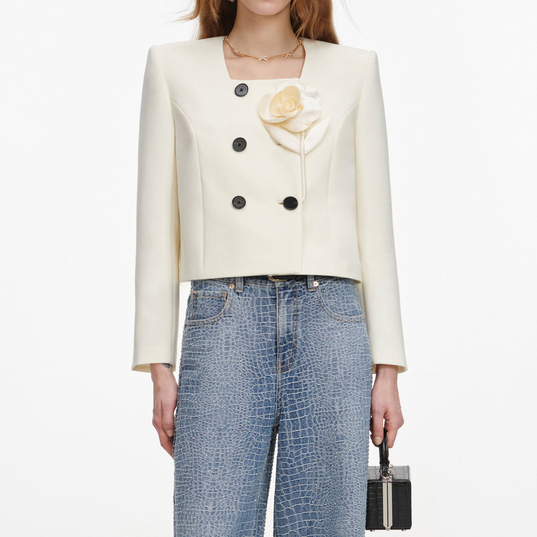 A close up of a woman wearing the Cream 3D Flower Jacket