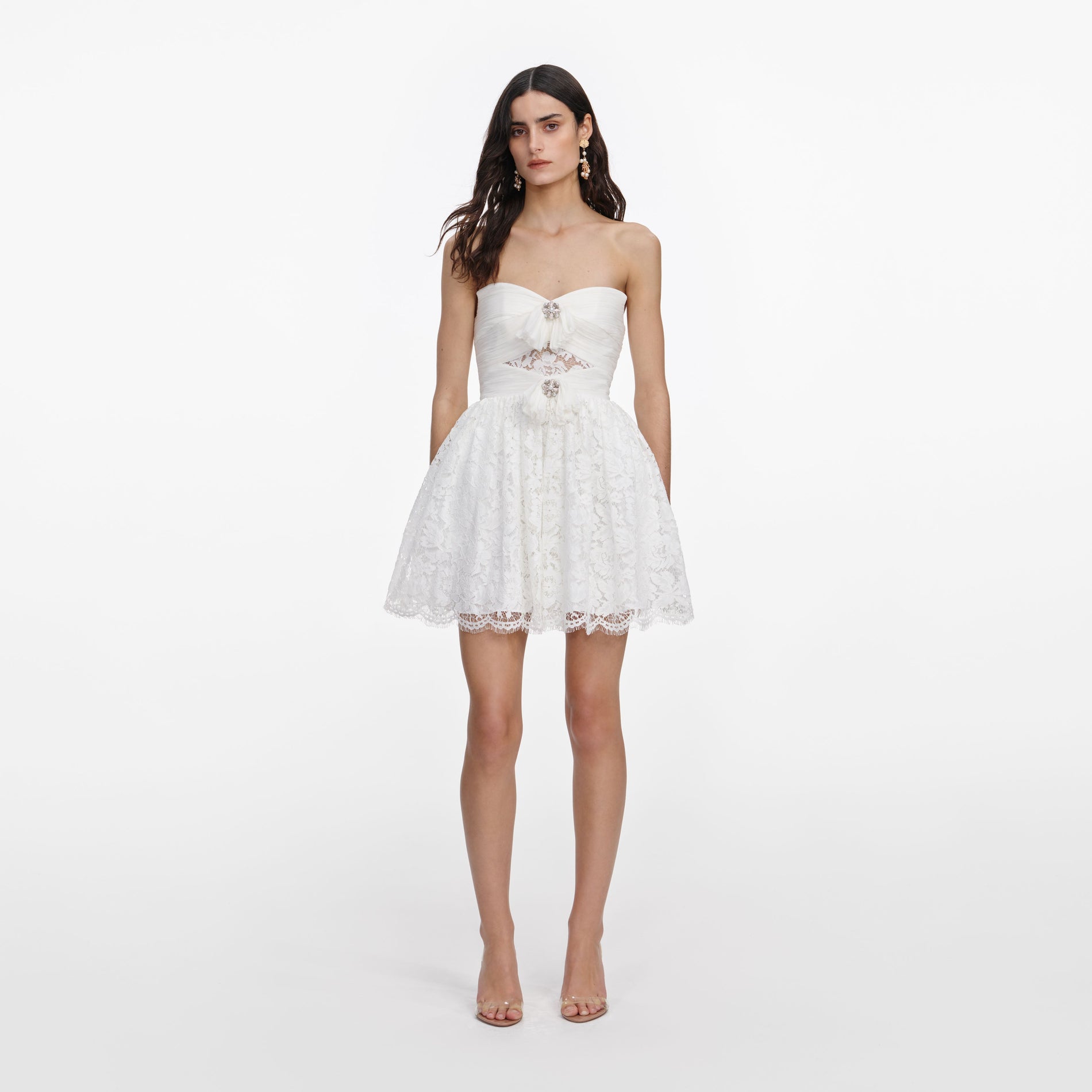 Front view of a woman wearing the White Lace Bow Mini Dress