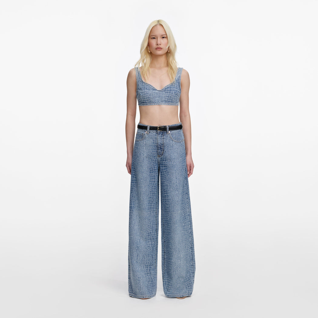 A close up of a woman wearing the Rhinestone Croc Effect Denim Bralette