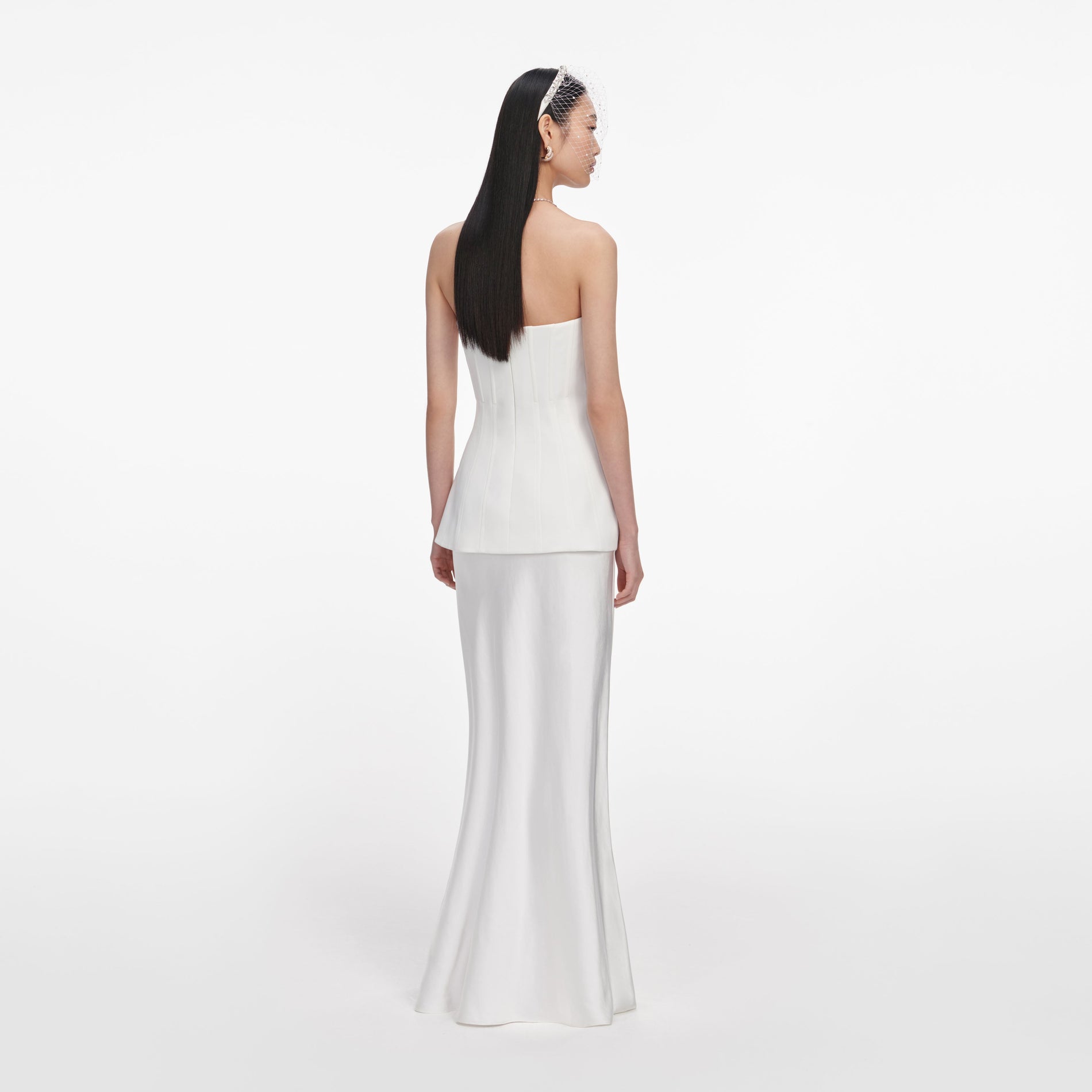 Back view of a woman wearing the White Bandeau Maxi Dress