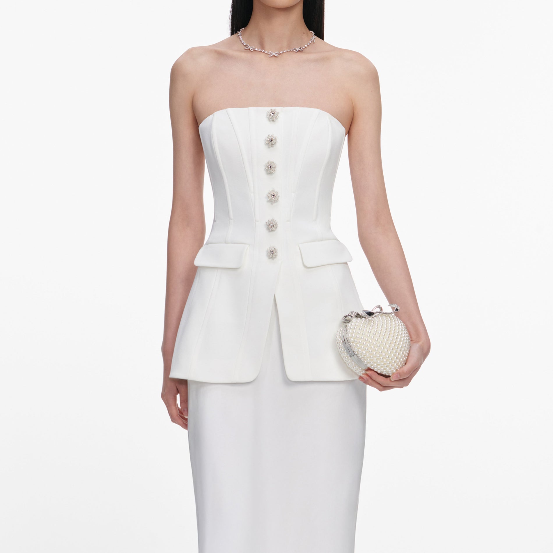 A close up of a woman wearing the White Bandeau Maxi Dress