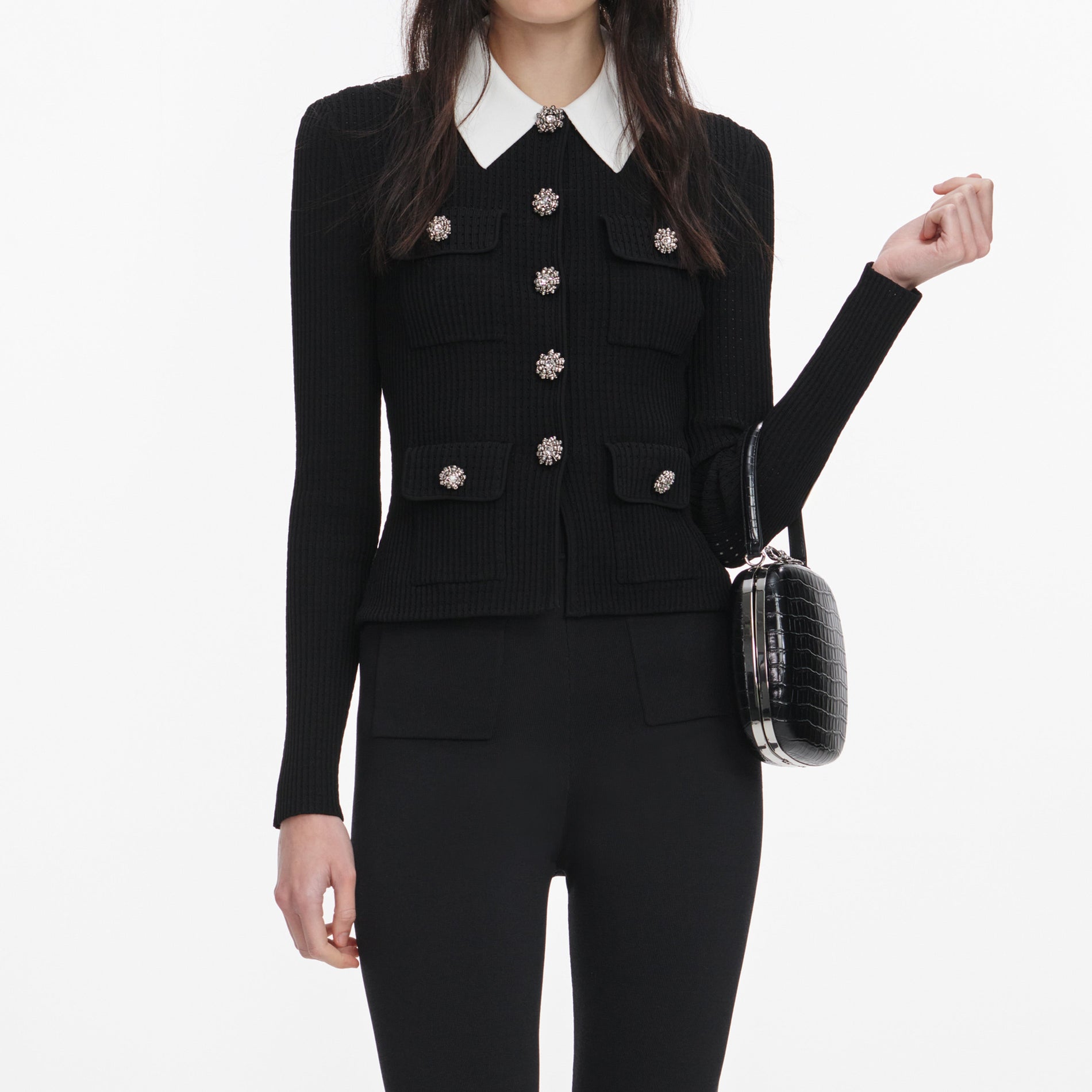 A close up of a woman wearing the Black Tailored Knit Top