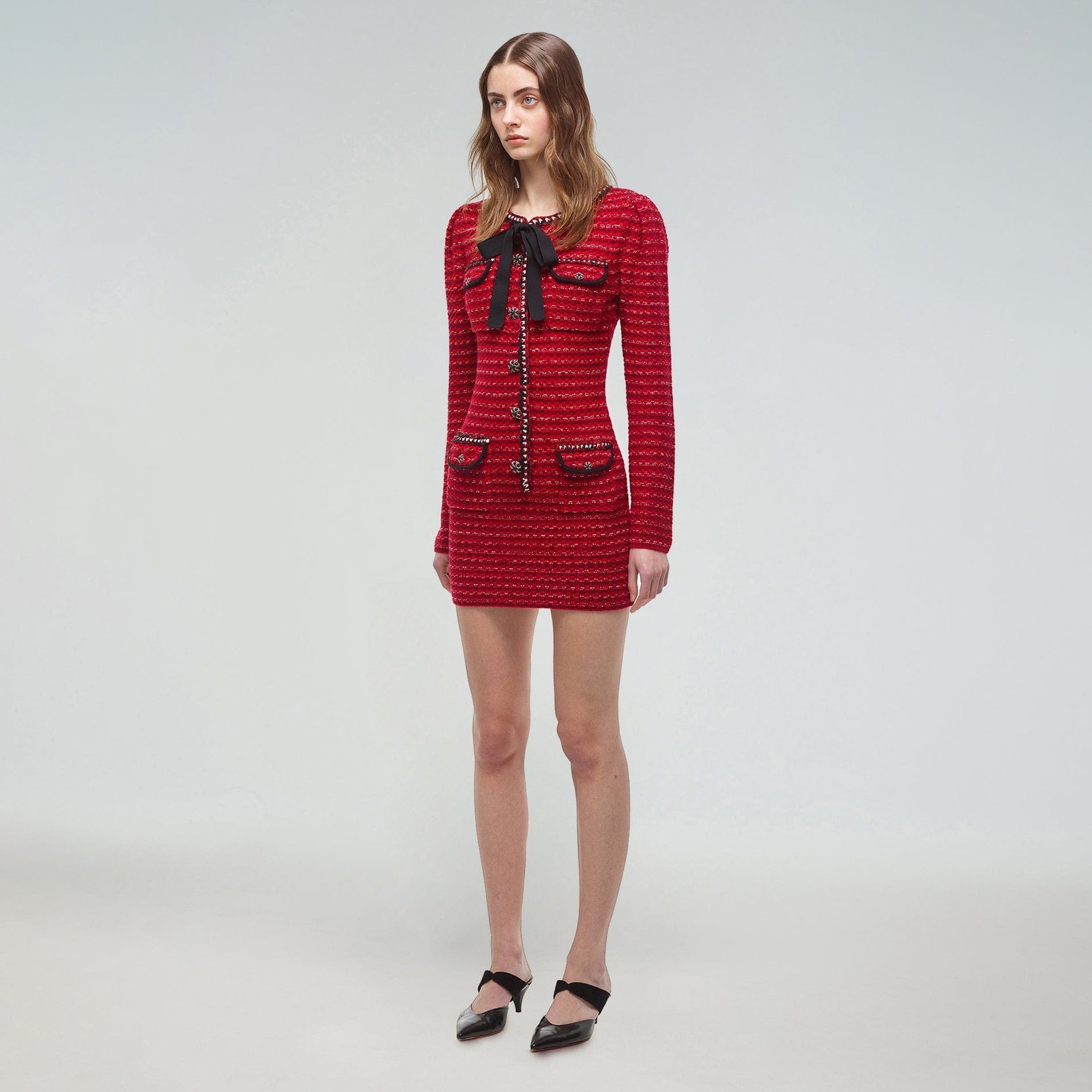 A woman wearing the Red Melange Fitted Knit Mini Dress