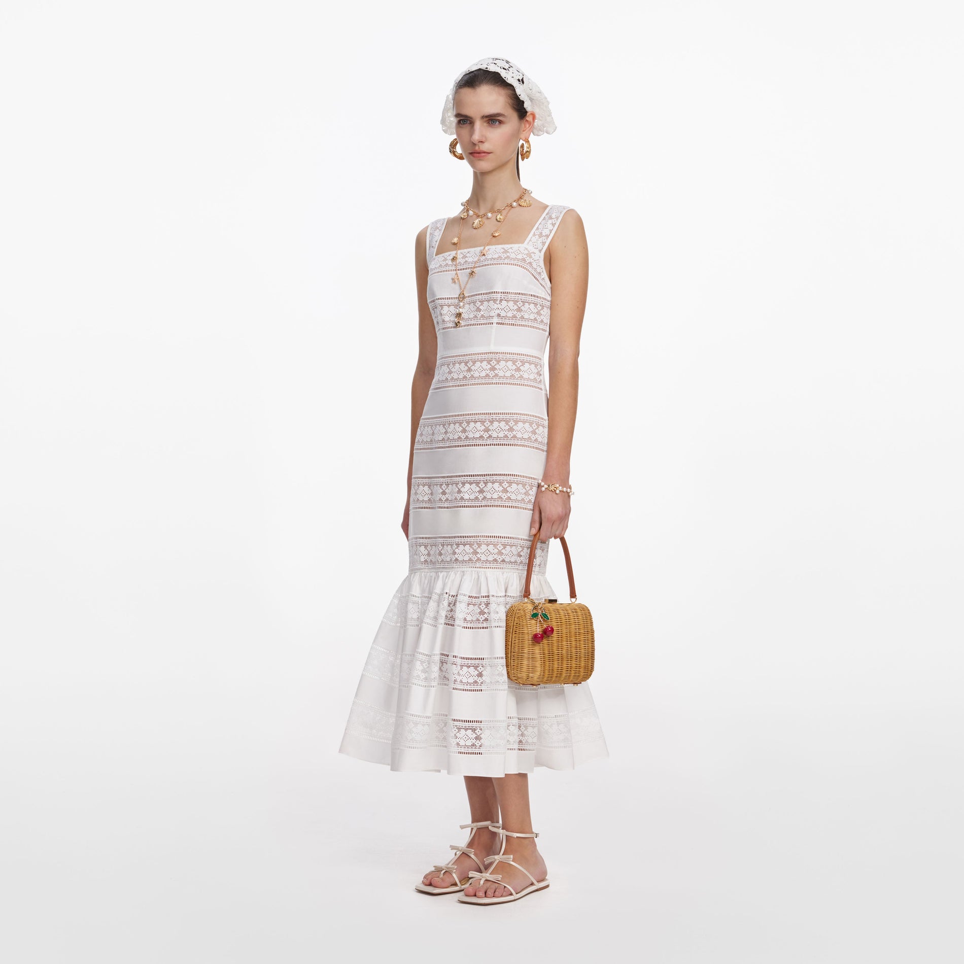 Side view of a woman wearing the White Cotton Embroidered Midi Dress