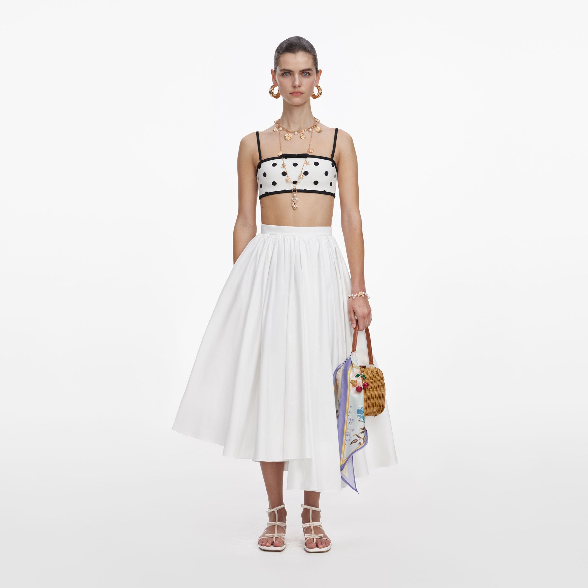 Front view of a woman wearing the White Polka Dot Bikini Top