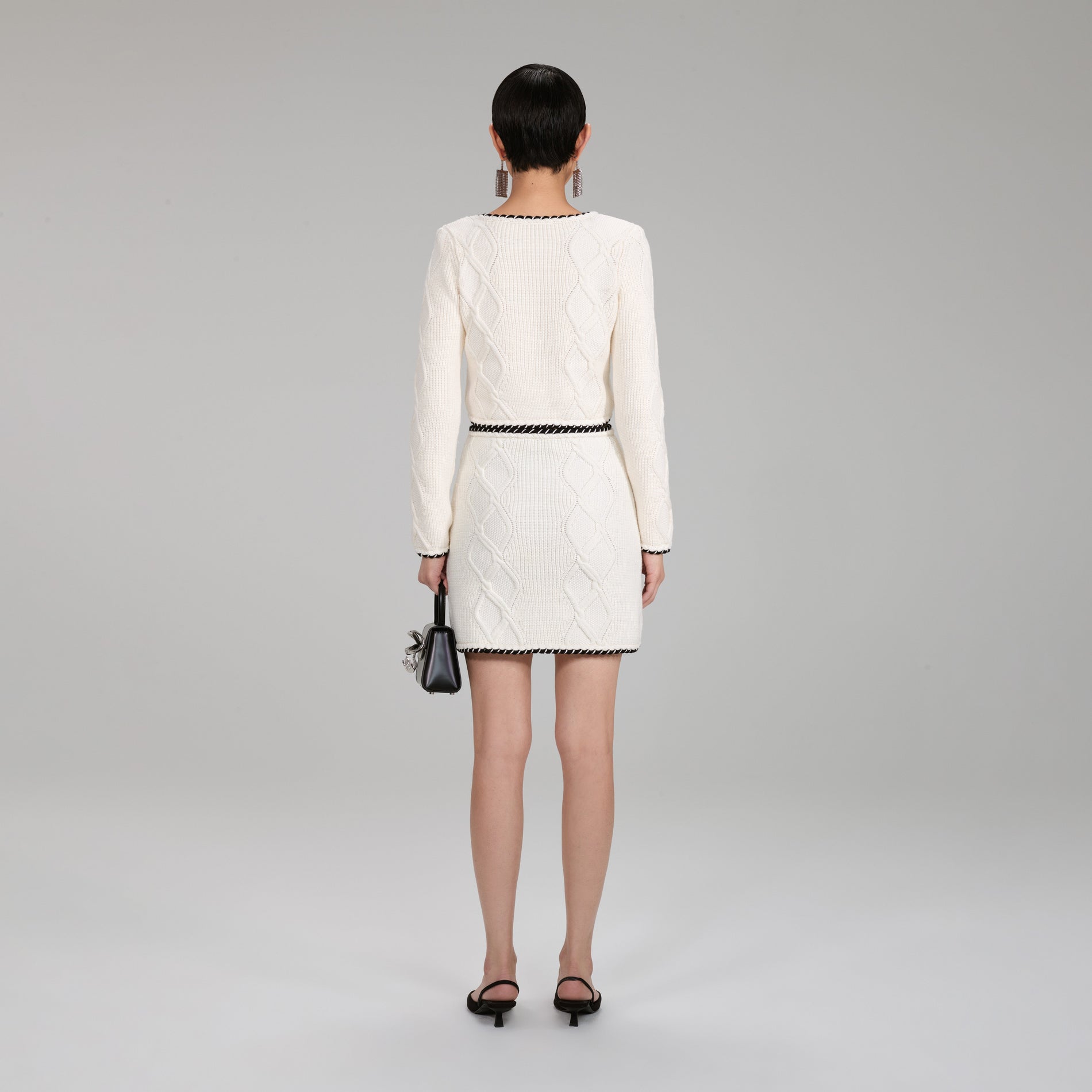 A woman wearing the Cable Knit Mini Skirt