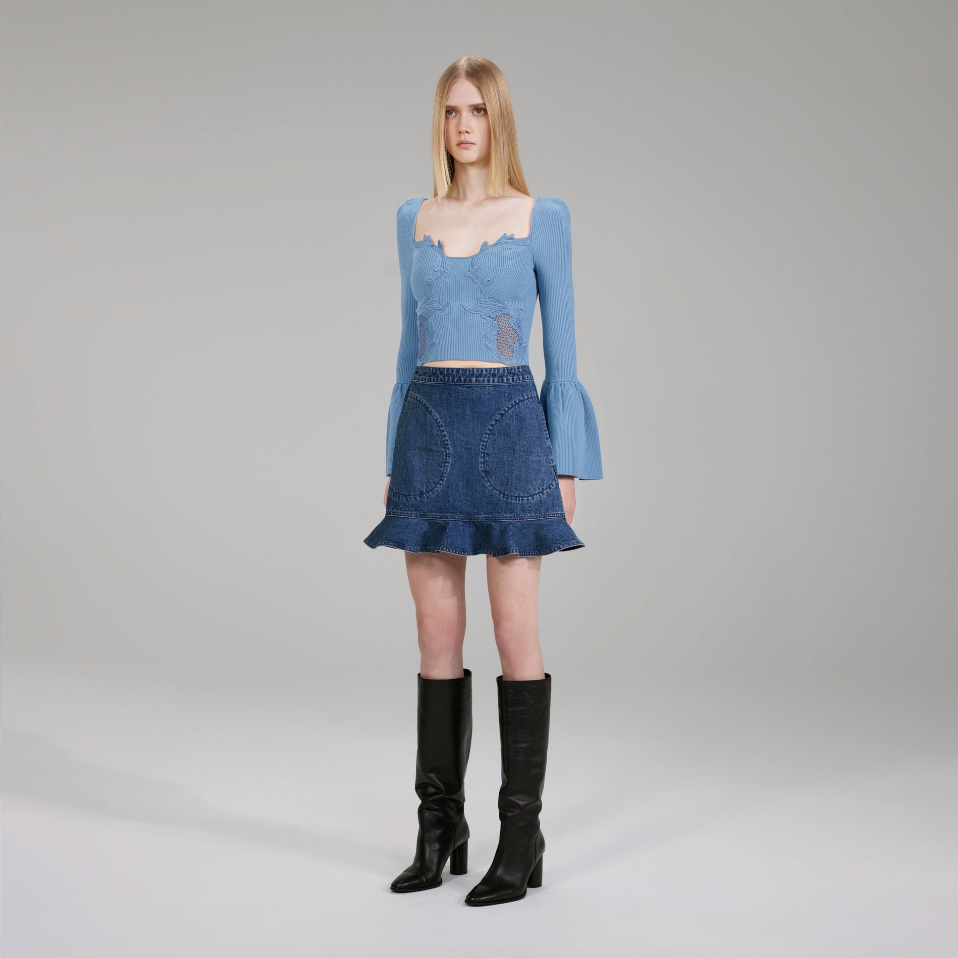 A woman wearing the Pastel Blue Lace Insert Ribbed Knit Top