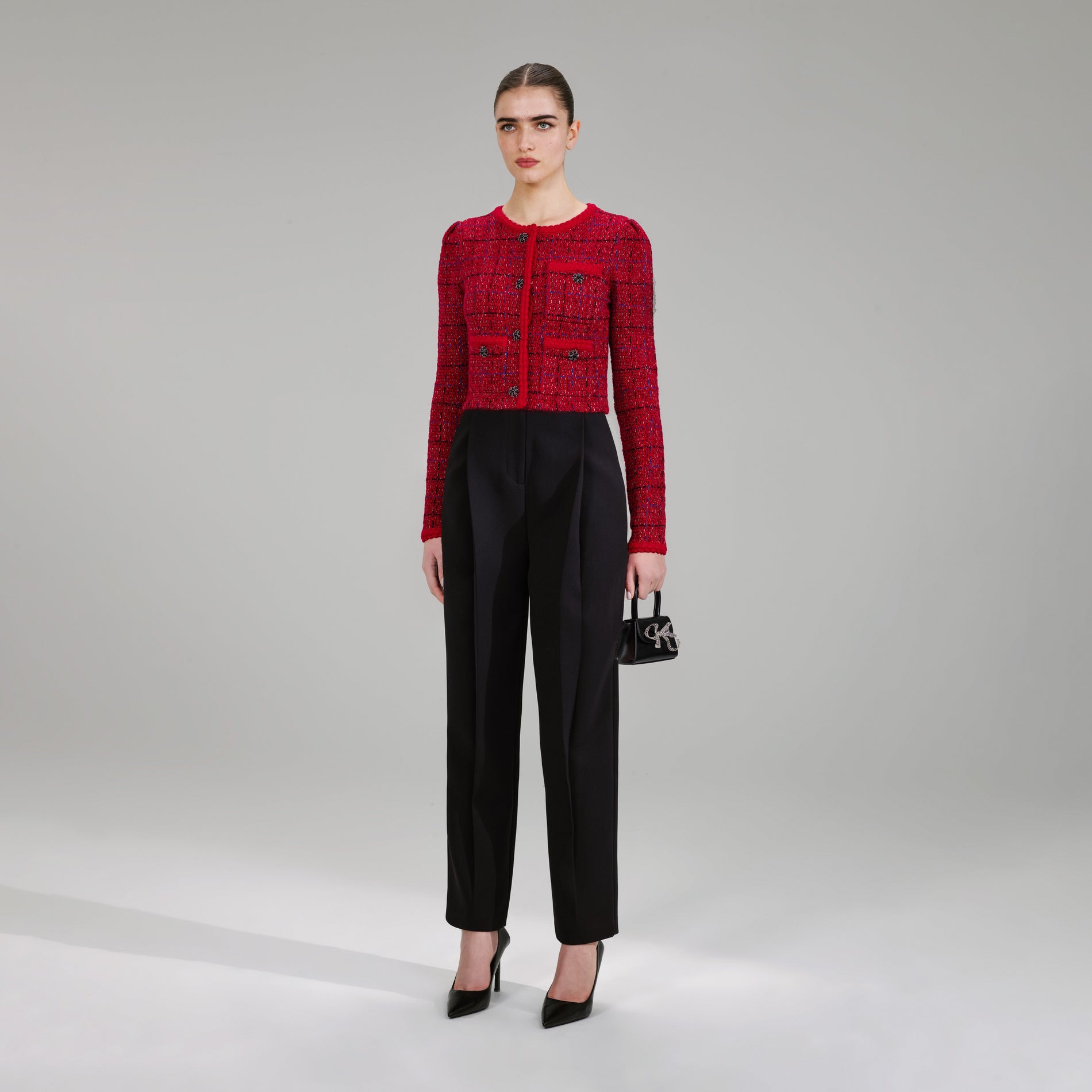 A woman wearing the Red Melange Knit Jacket