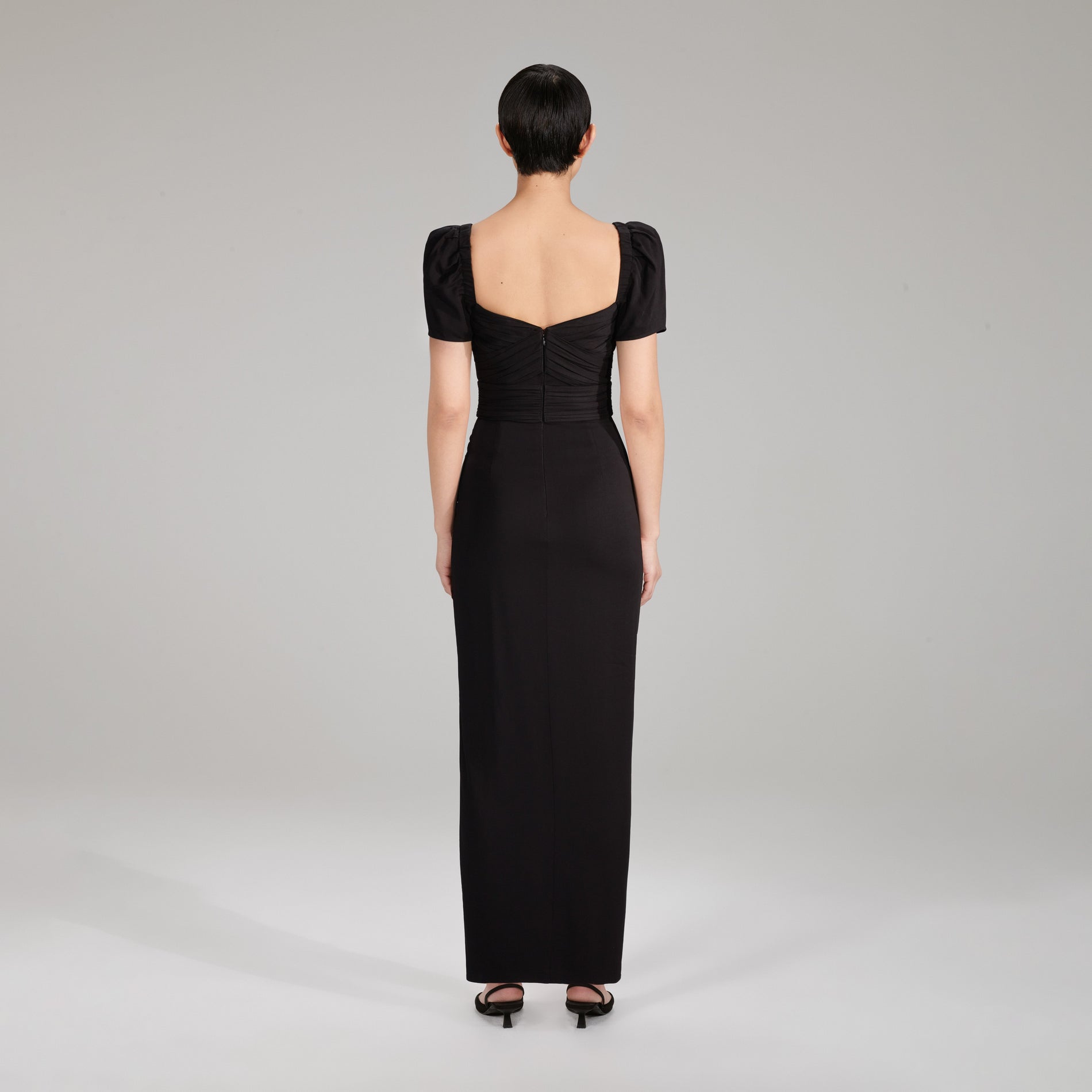 A woman wearing the Black Maxi Stretch Crepe Dress