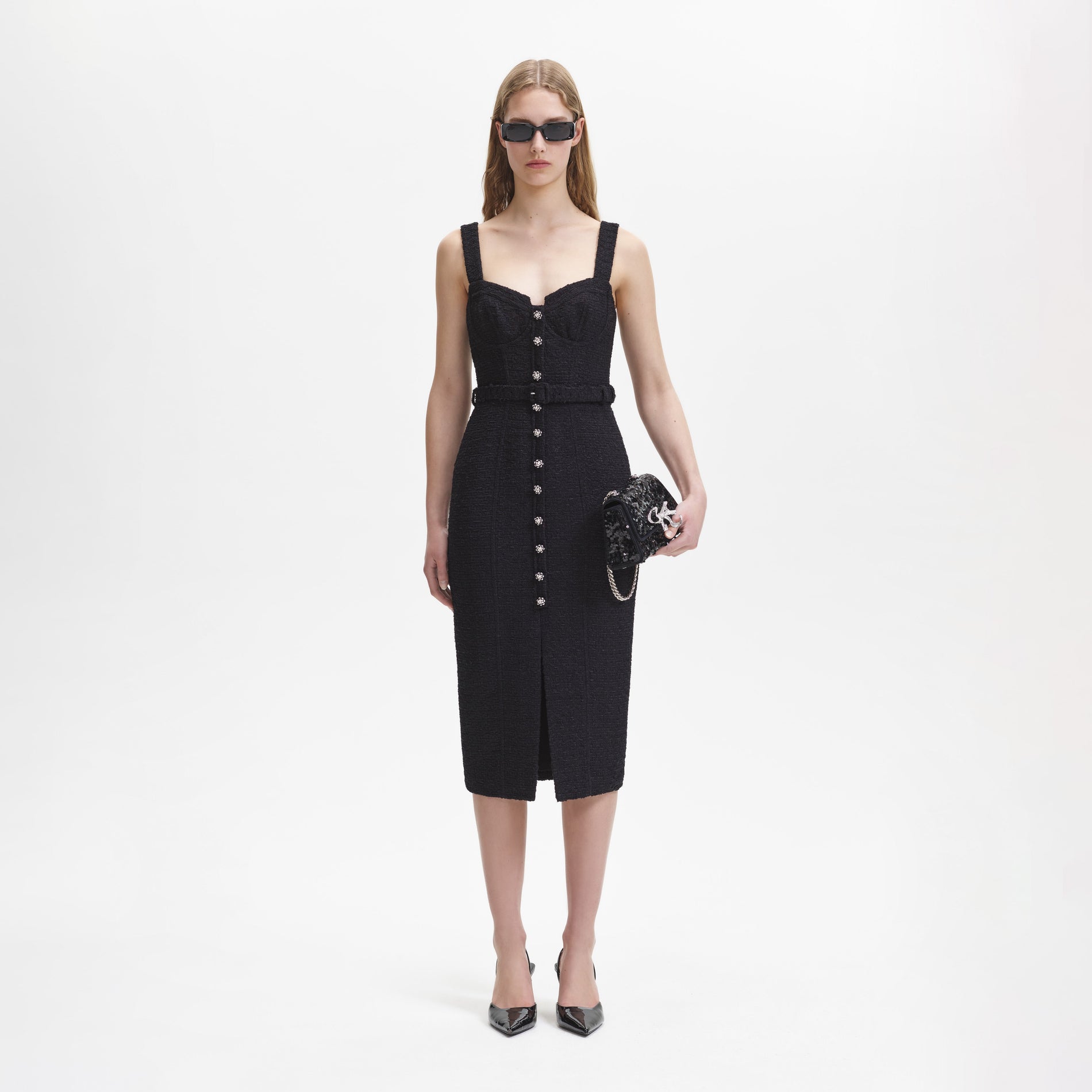 A woman wearing the Black Boucle Sweetheart Midi Dress