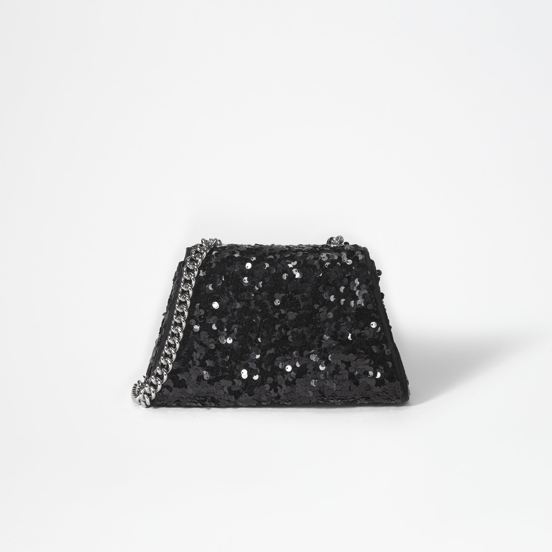 A woman wearing the Black Sequin Bow Mini Shoulder Bag