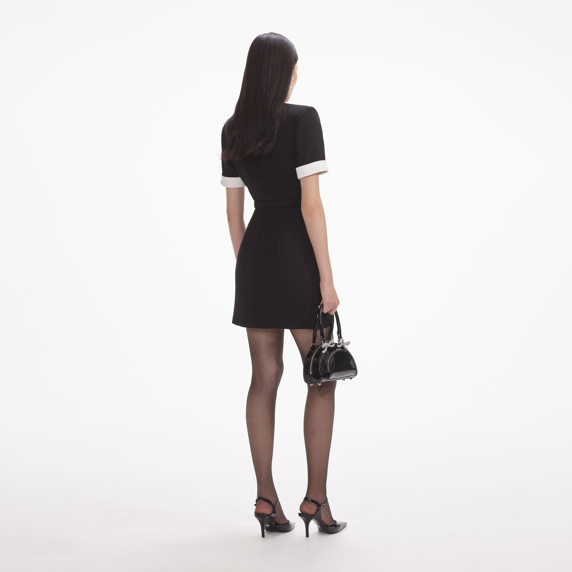 Back view of a woman wearing the White Black Crepe Contrast Mini Dress