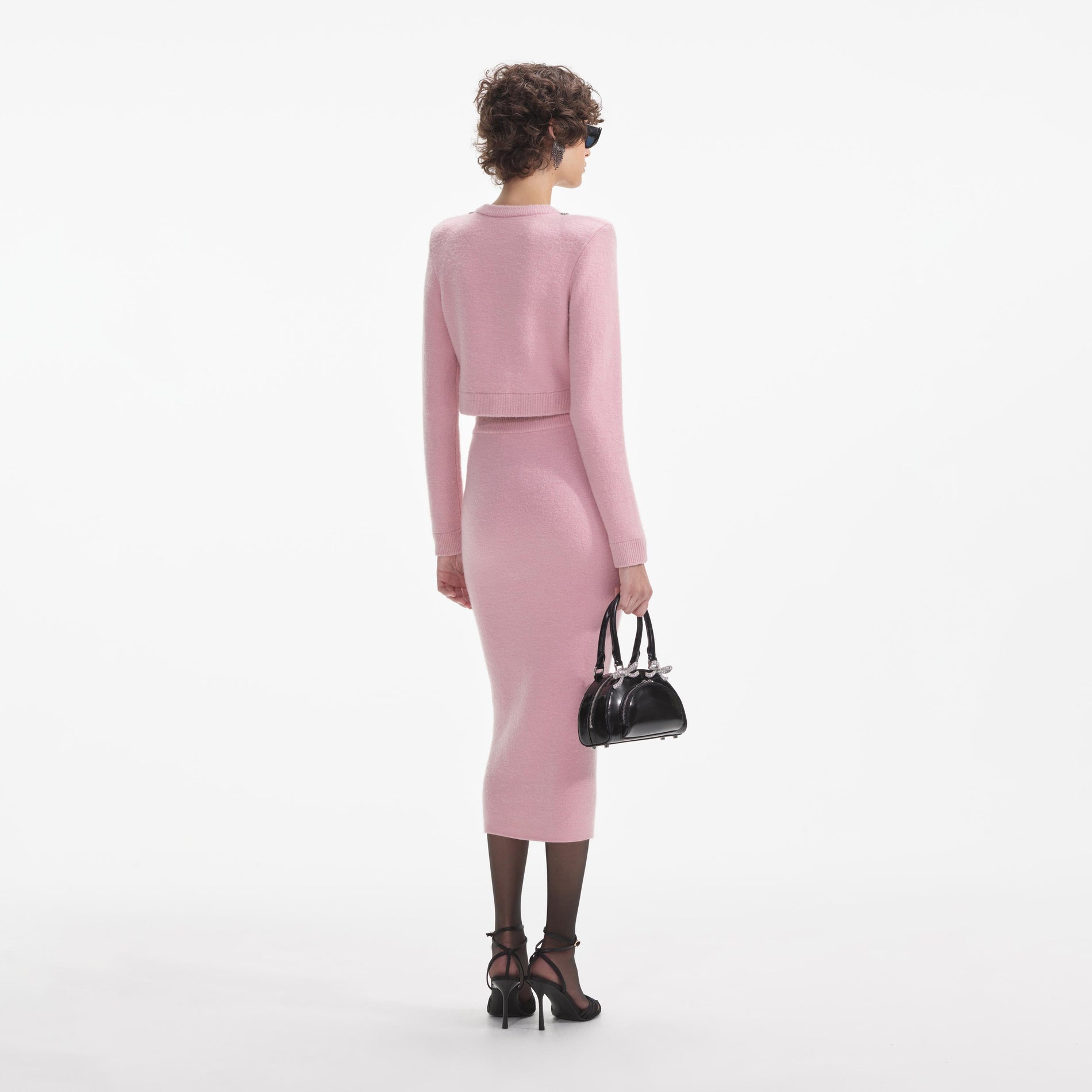 Back view of a woman wearing the White Pink Embellished Knit Midi Skirt