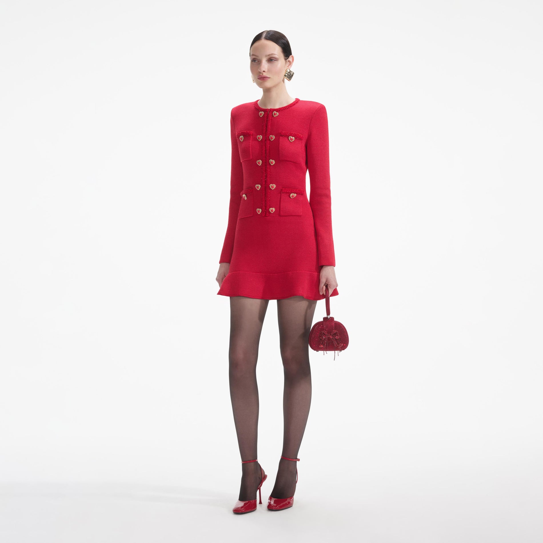 Side view of a woman wearing the Red Knit Heart Buttoned Mini Dress