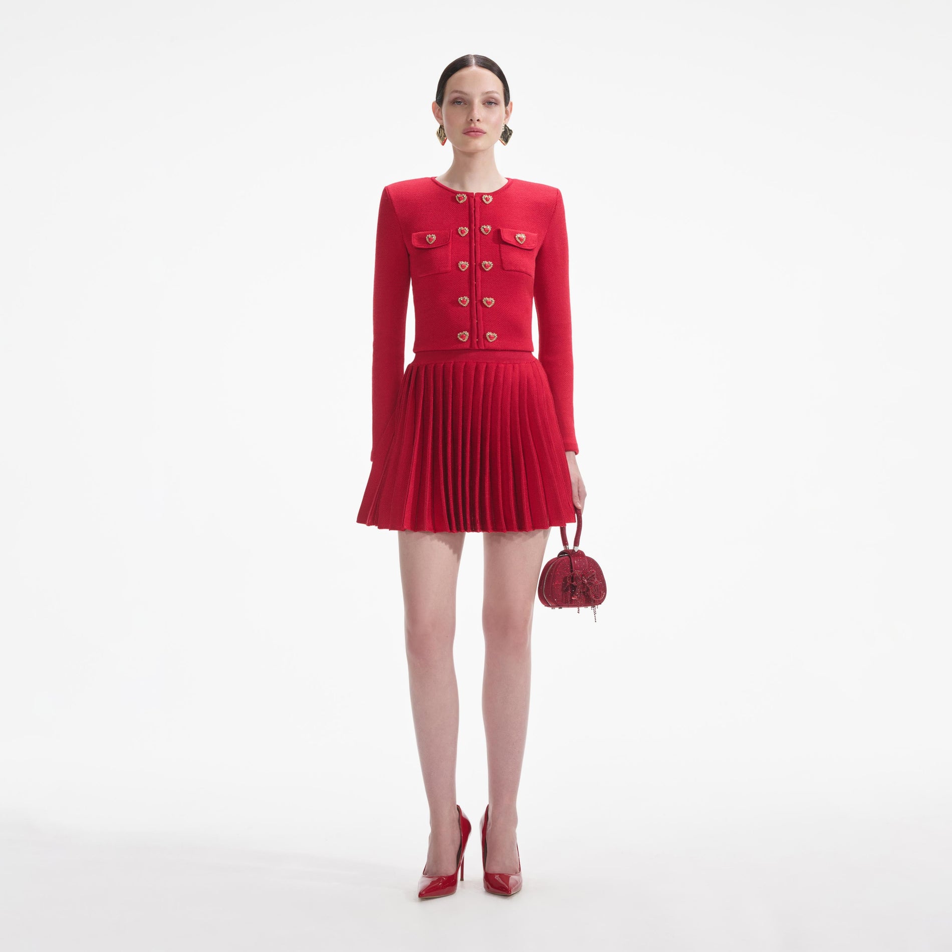 Front view of a woman wearing the Red Pleated Knit Mini Skirt