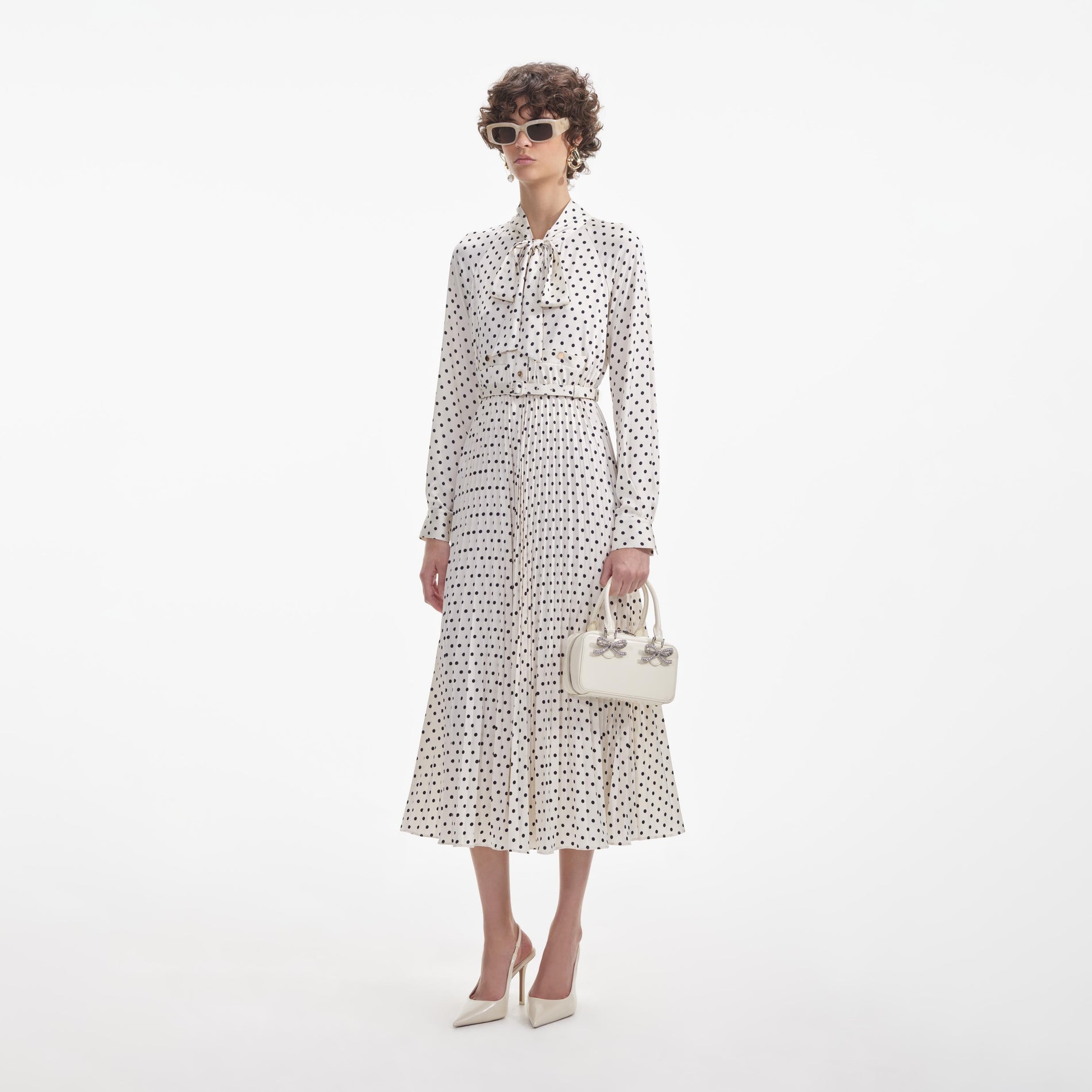 Side view of a woman wearing the Cream Polka Dot Satin Midi Dress