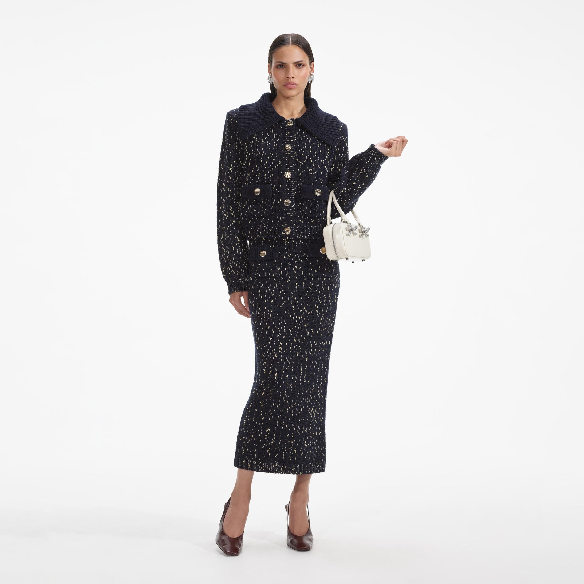 Front view of a woman wearing the Navy Metallic Merino Knit Midi Skirt